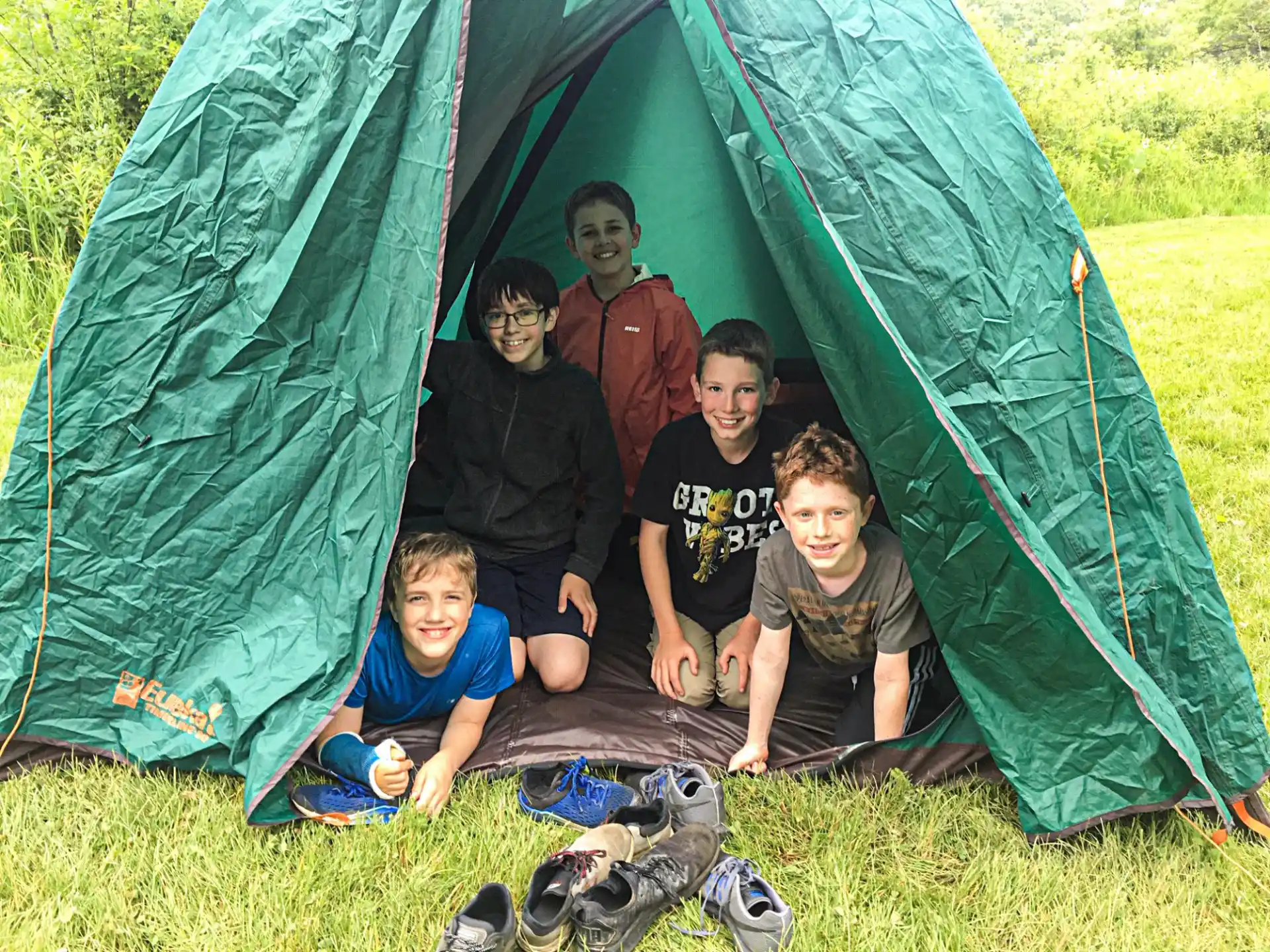 a group of people posing for a photo in front of a tent
