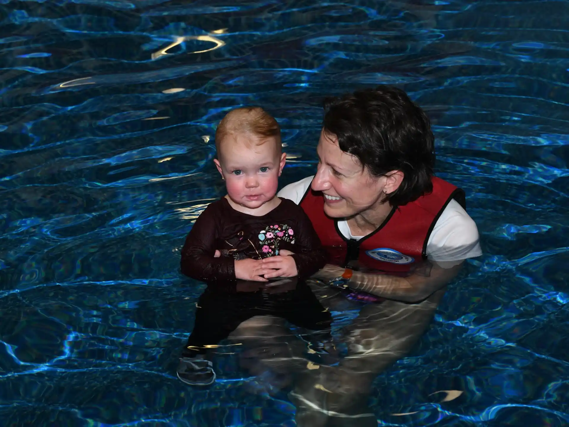 a man and a baby in a pool
