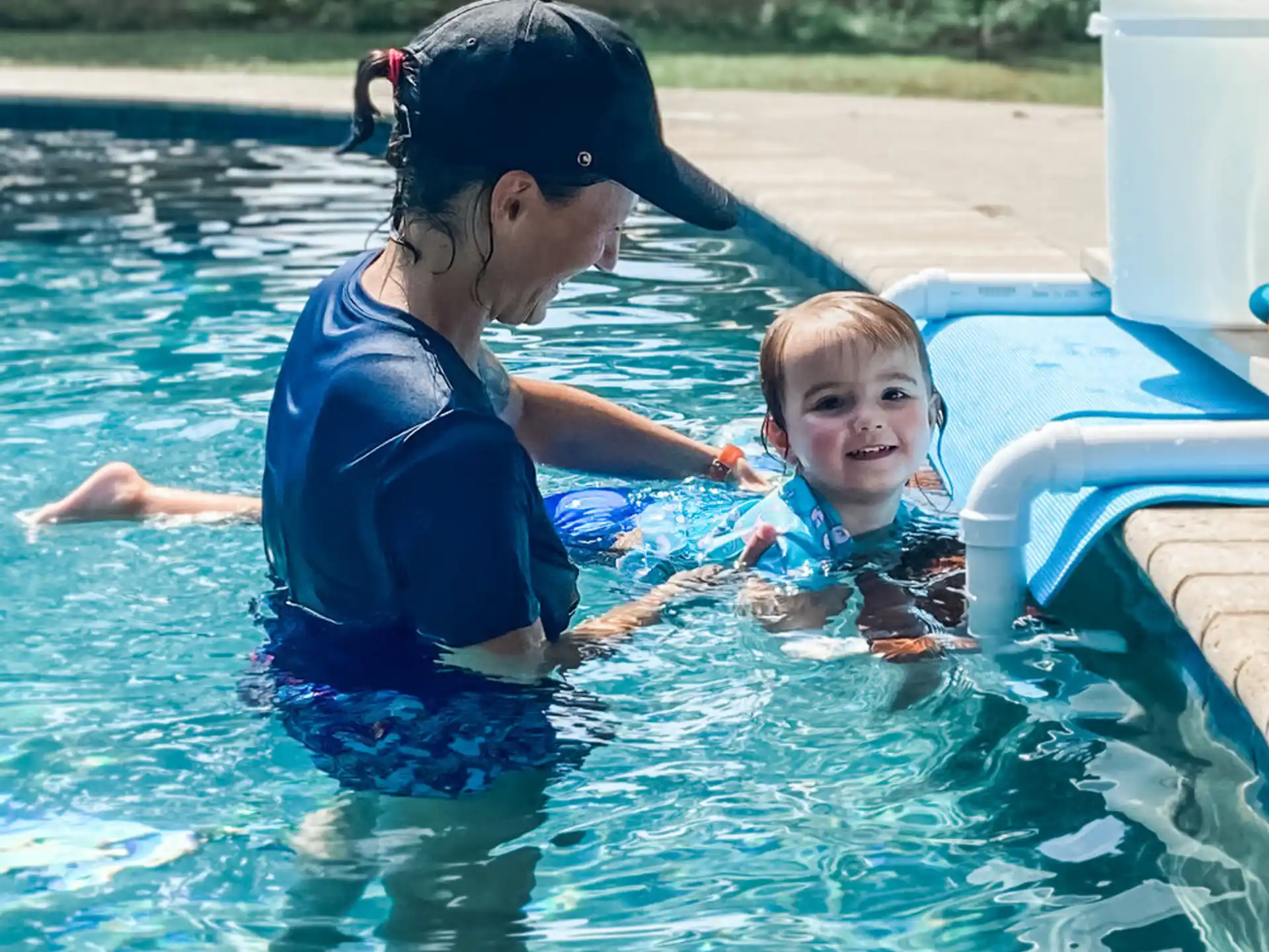 a person and a baby in a pool