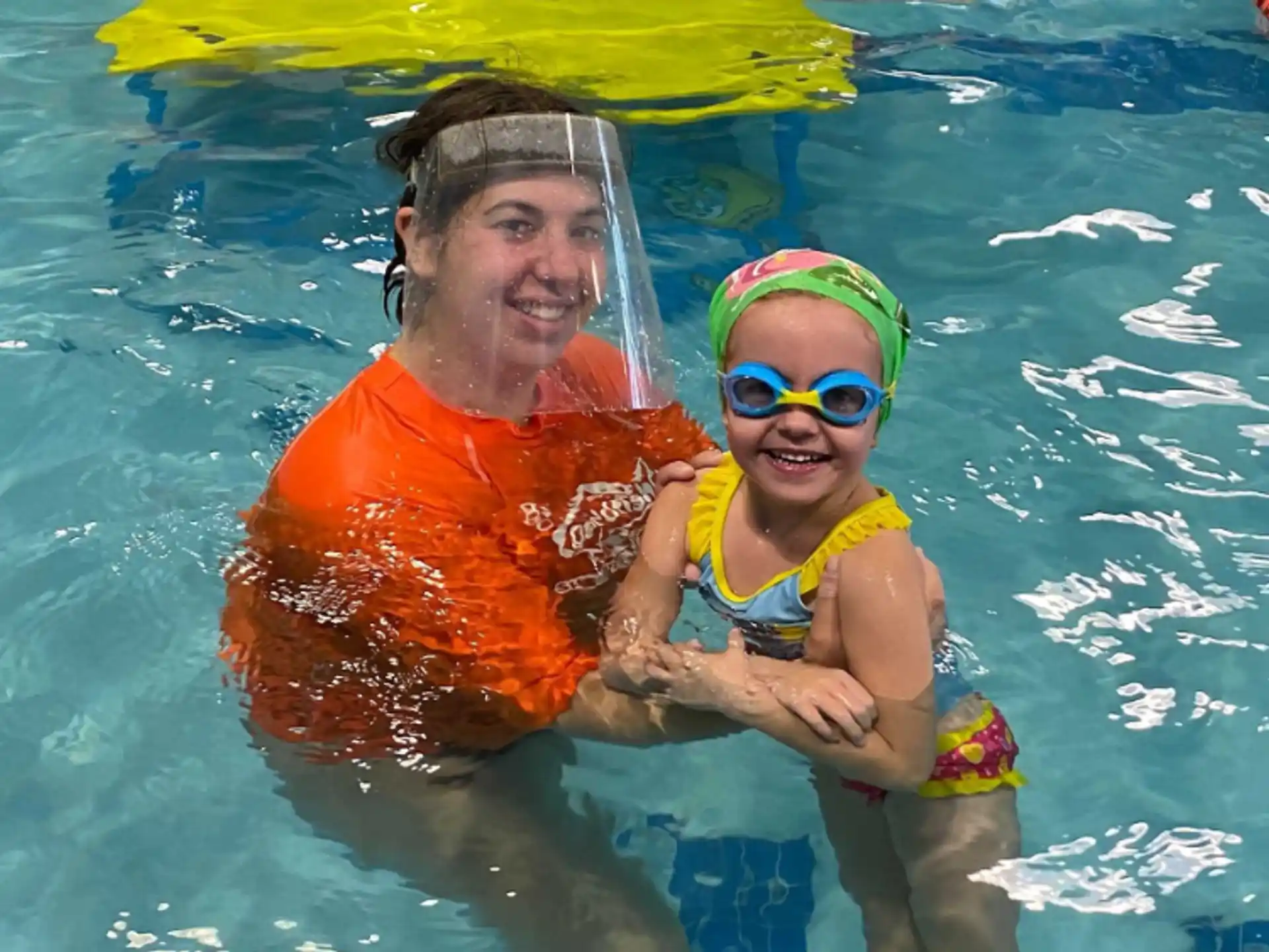 a person and a child in a pool