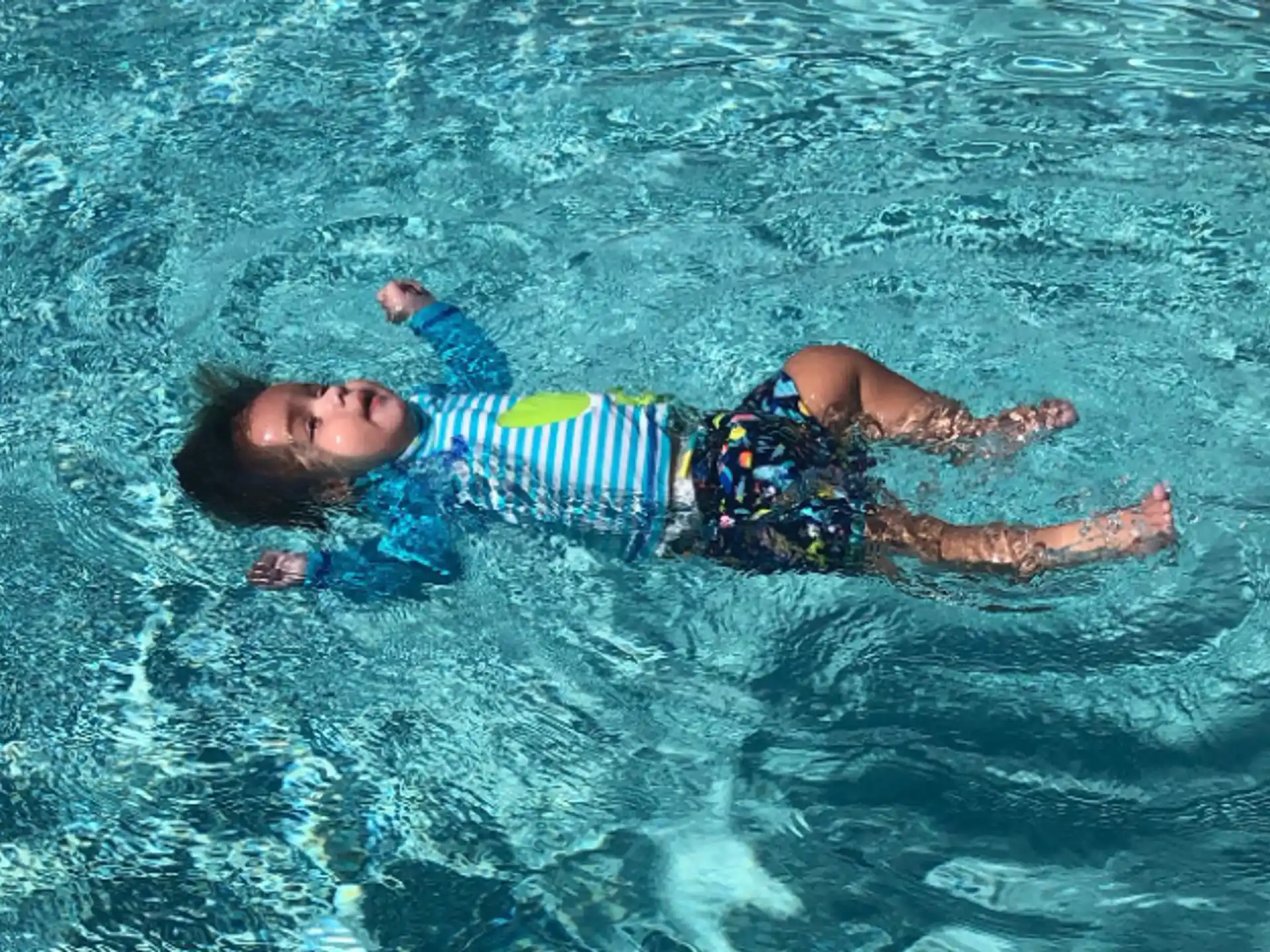 a boy swimming in water