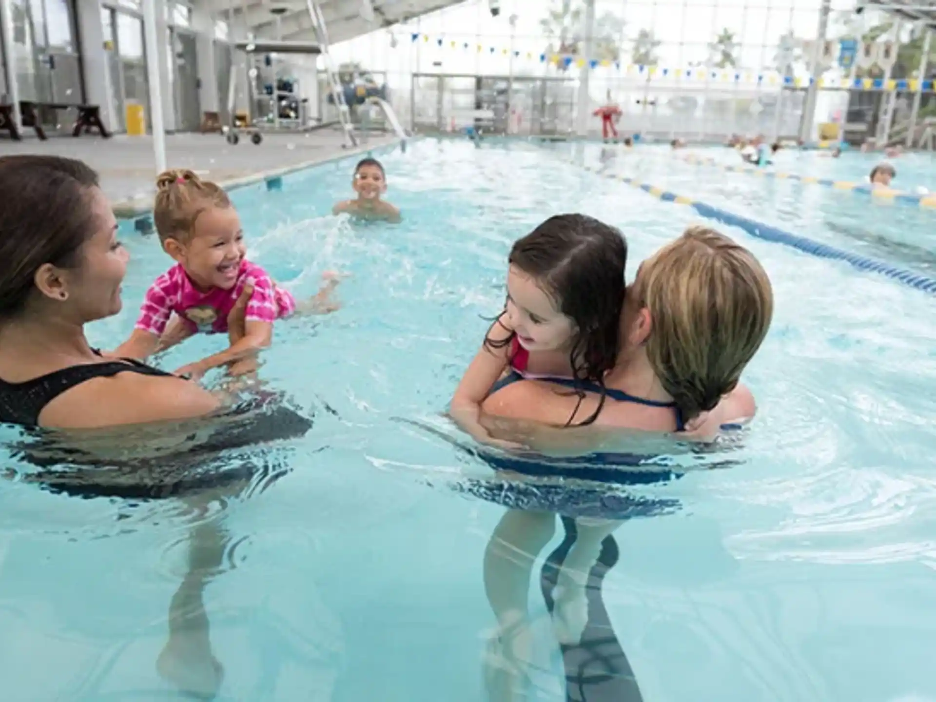 a person and a baby in a pool