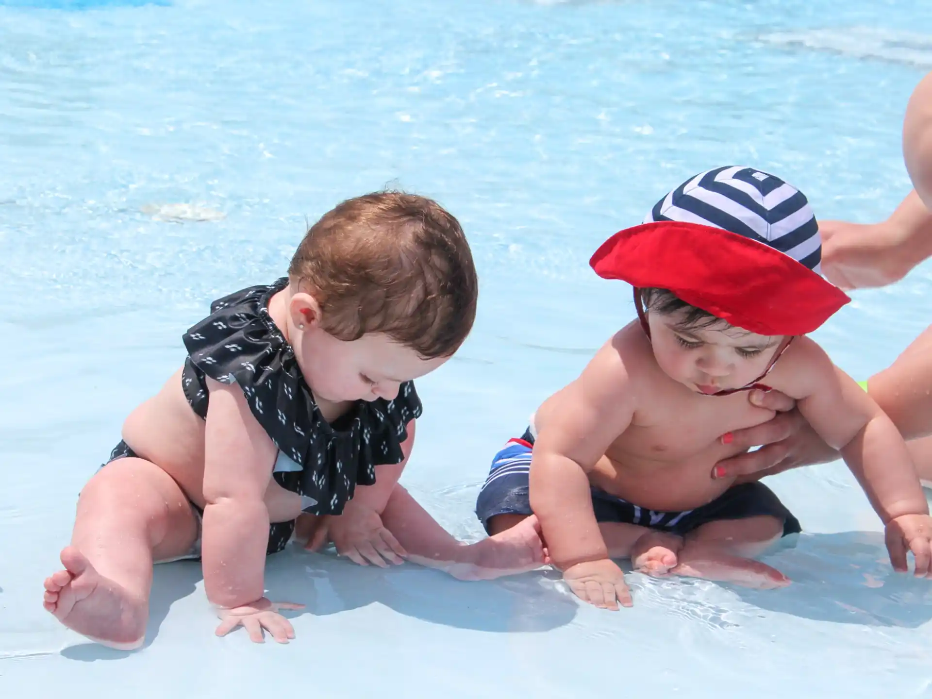 a person and a baby in a pool