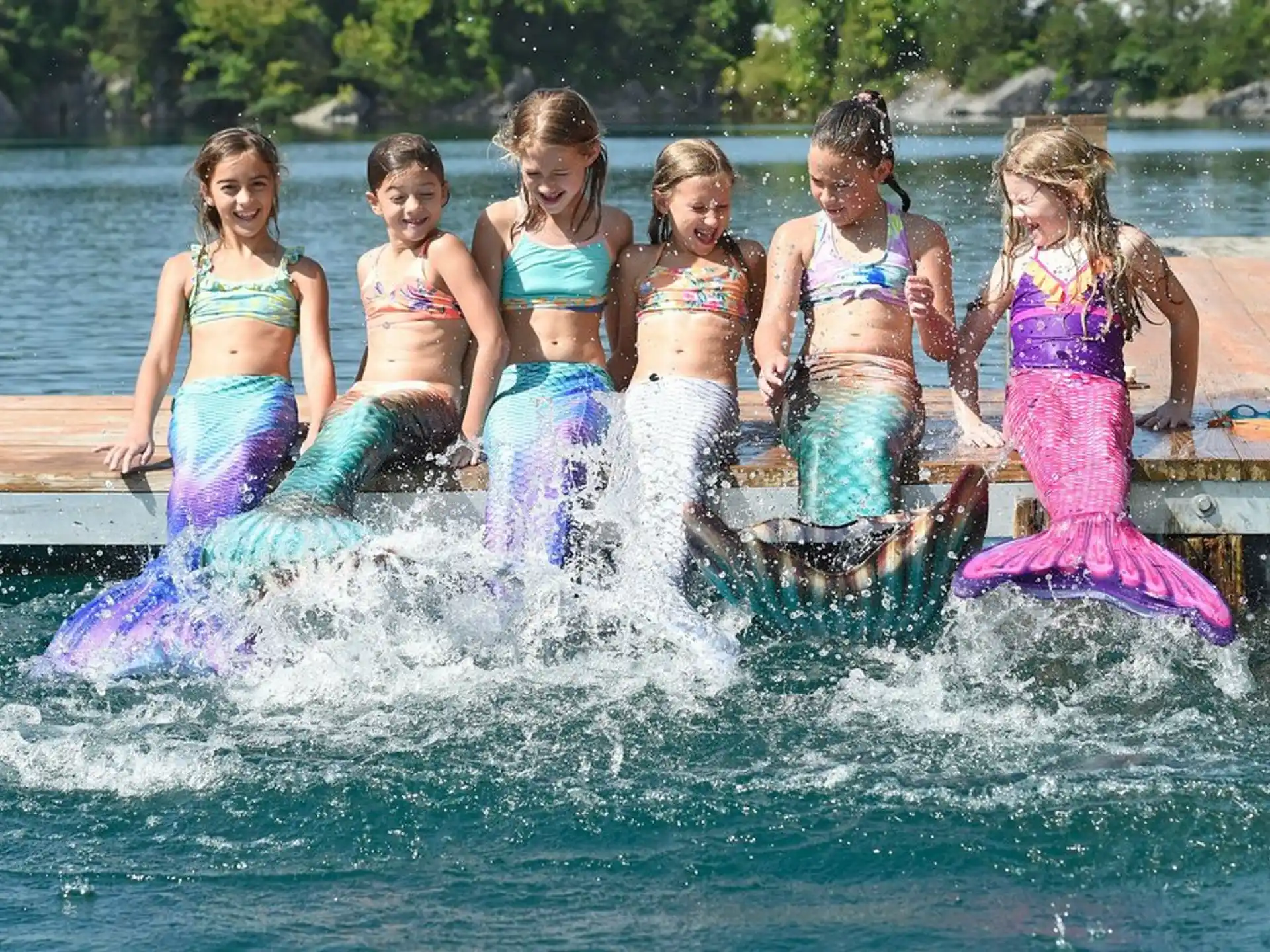 a group of girls in swimsuits in a pool