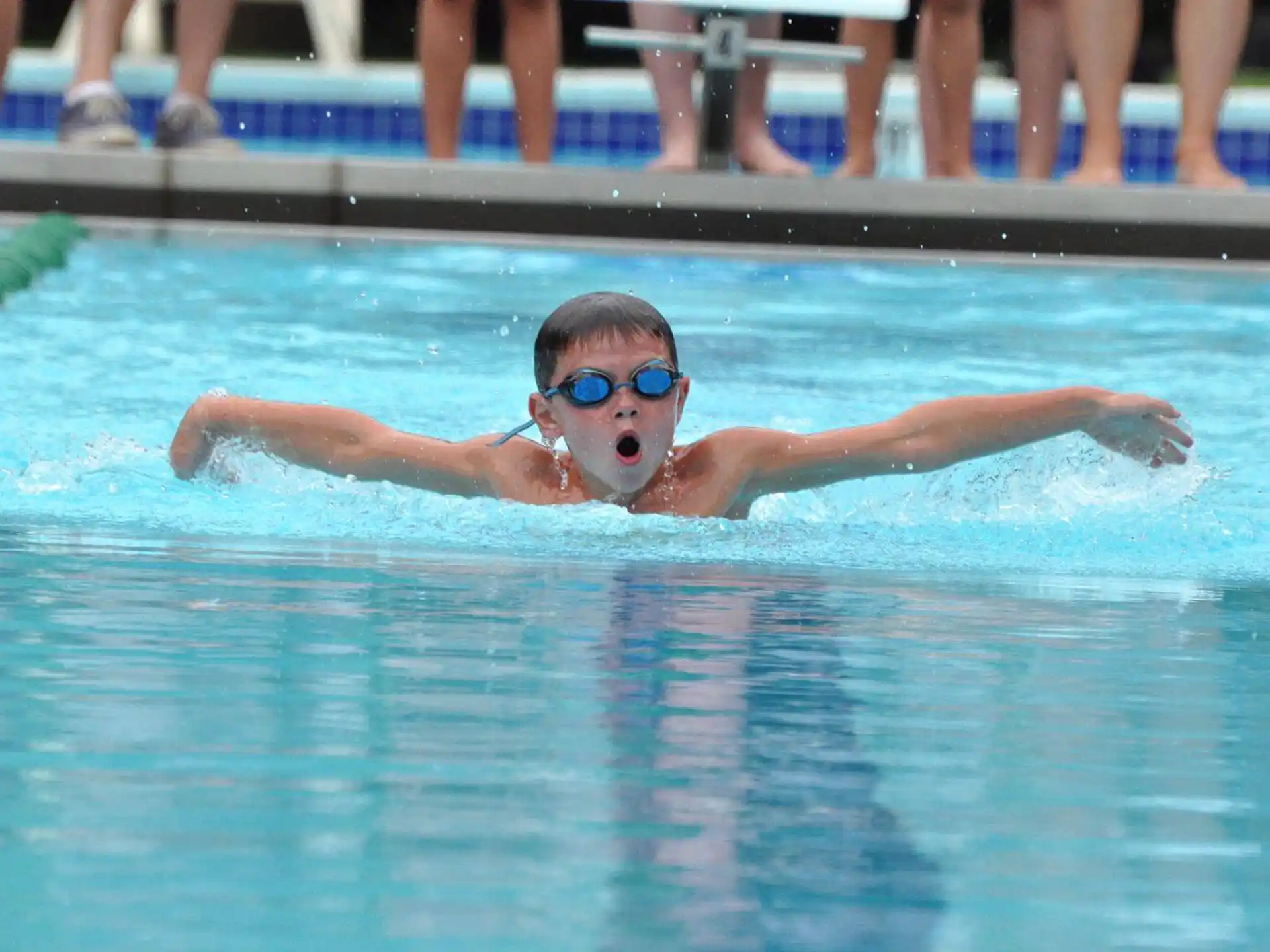 a boy swimming in a pool