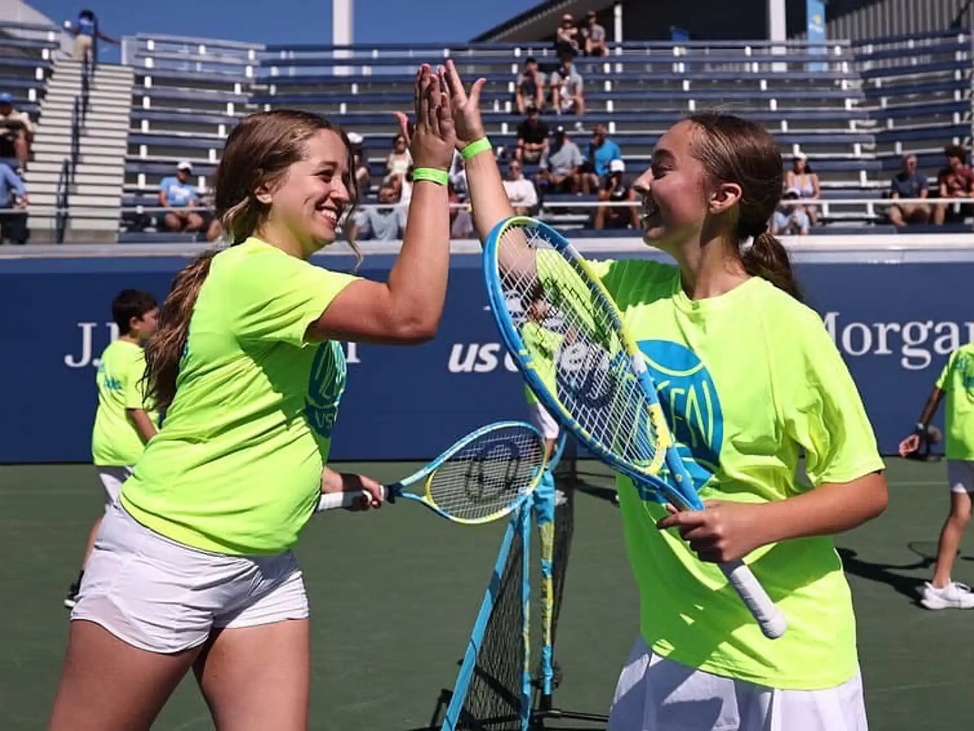women holding tennis rackets