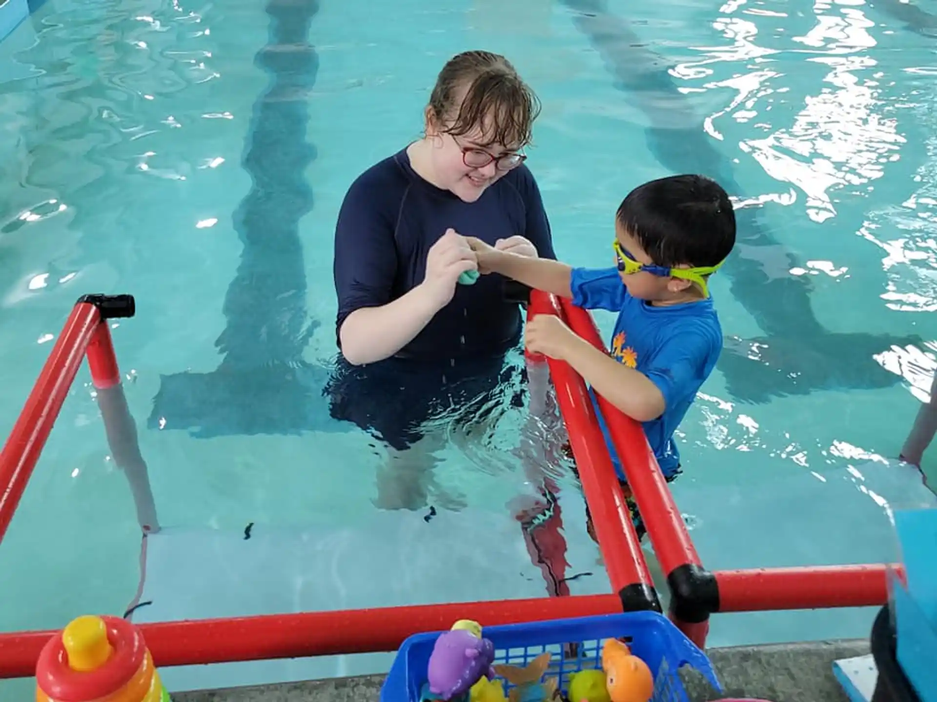 a person and a boy in a pool