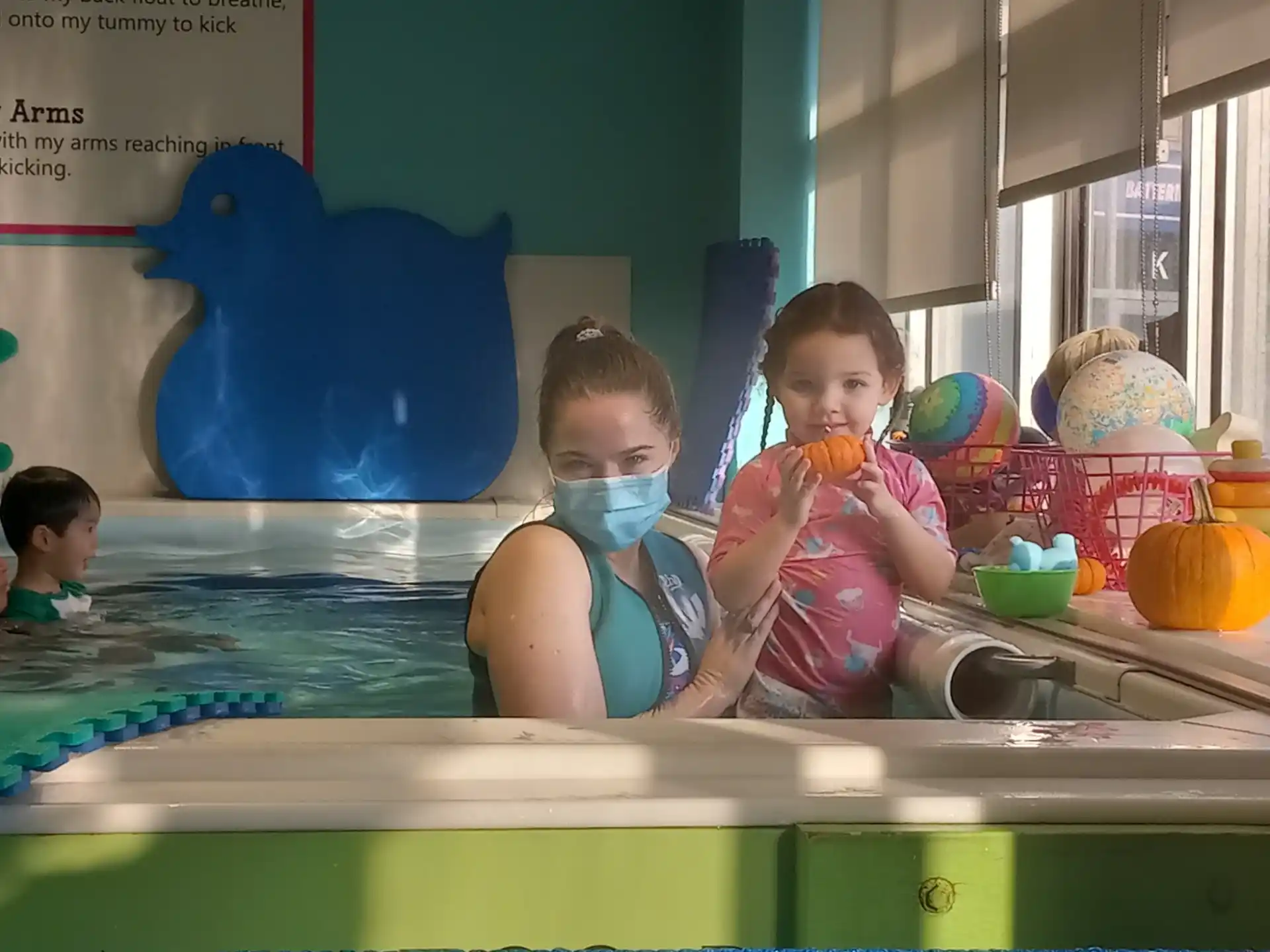 a couple of kids in a pool