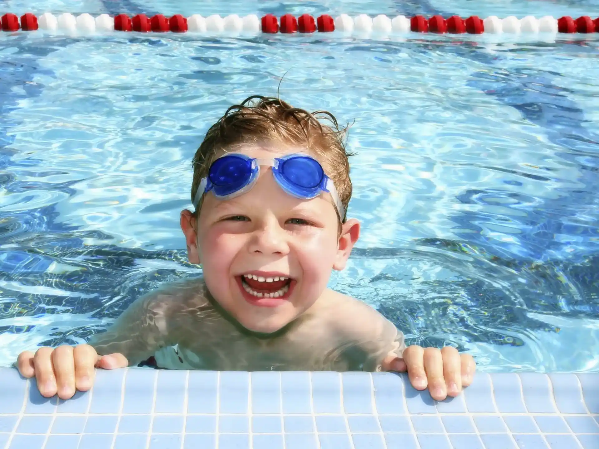 a baby in a pool wearing goggles