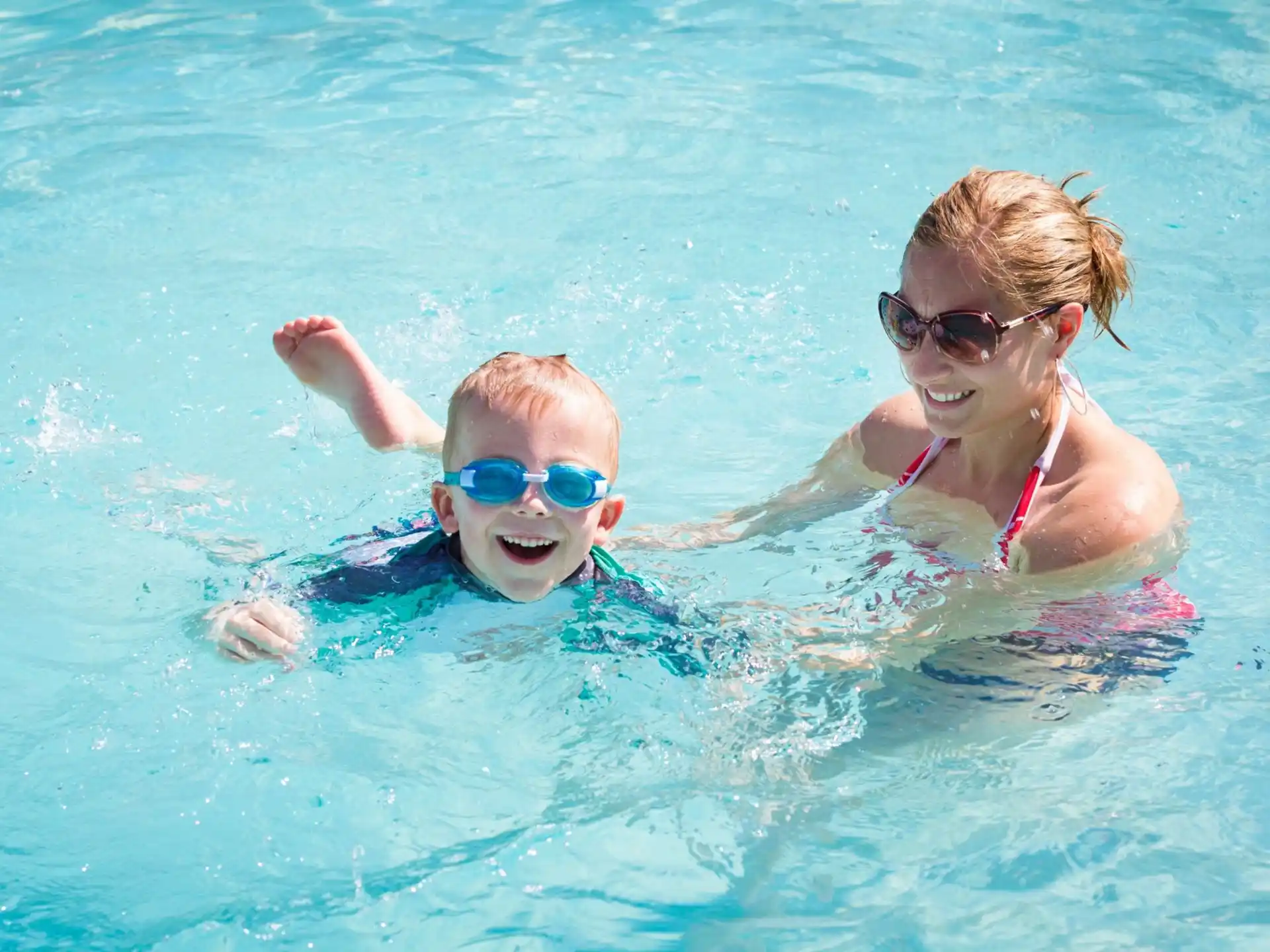 a person and a baby in a pool