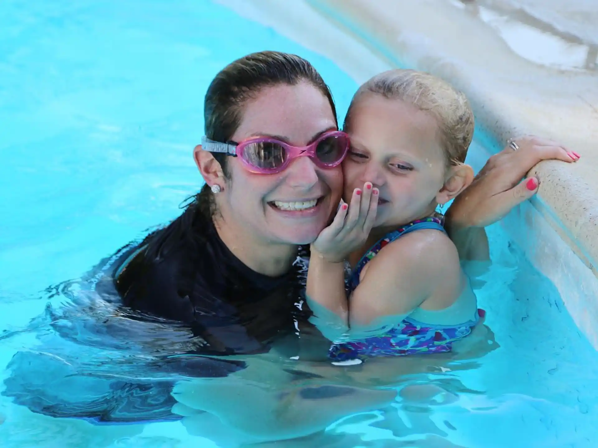 a man and a baby in a pool
