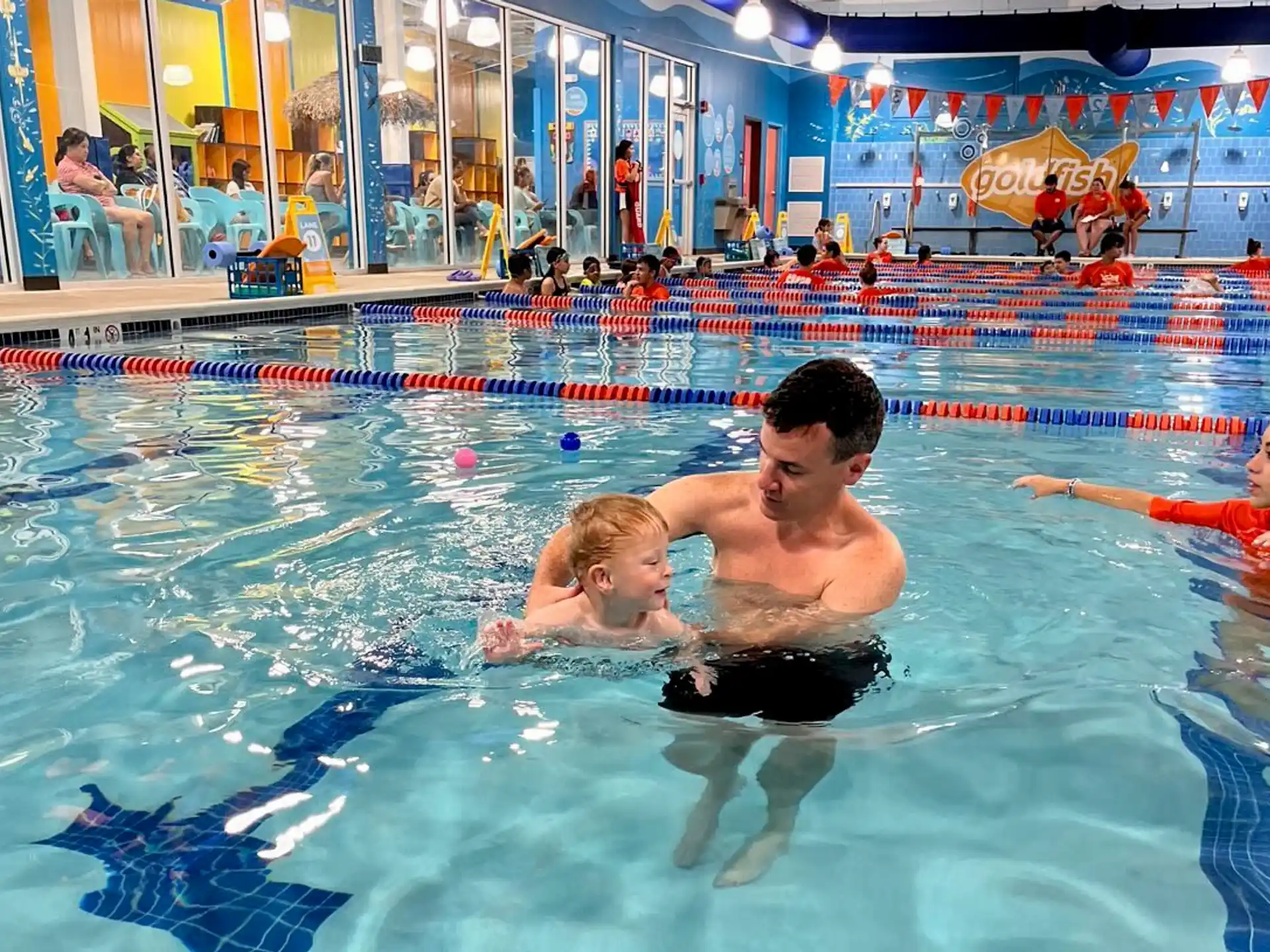 a person and a baby in a pool