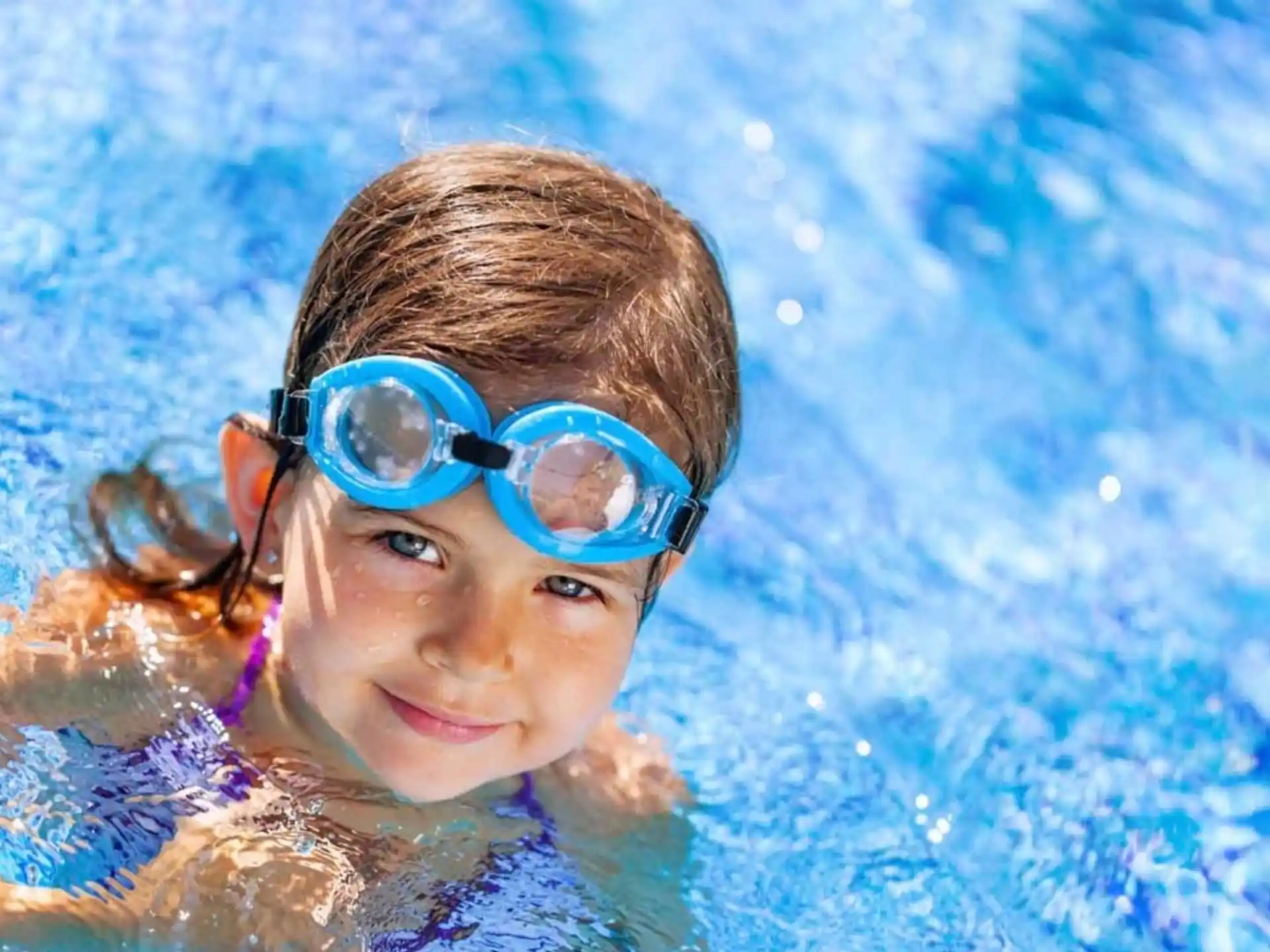 a person wearing goggles in a pool