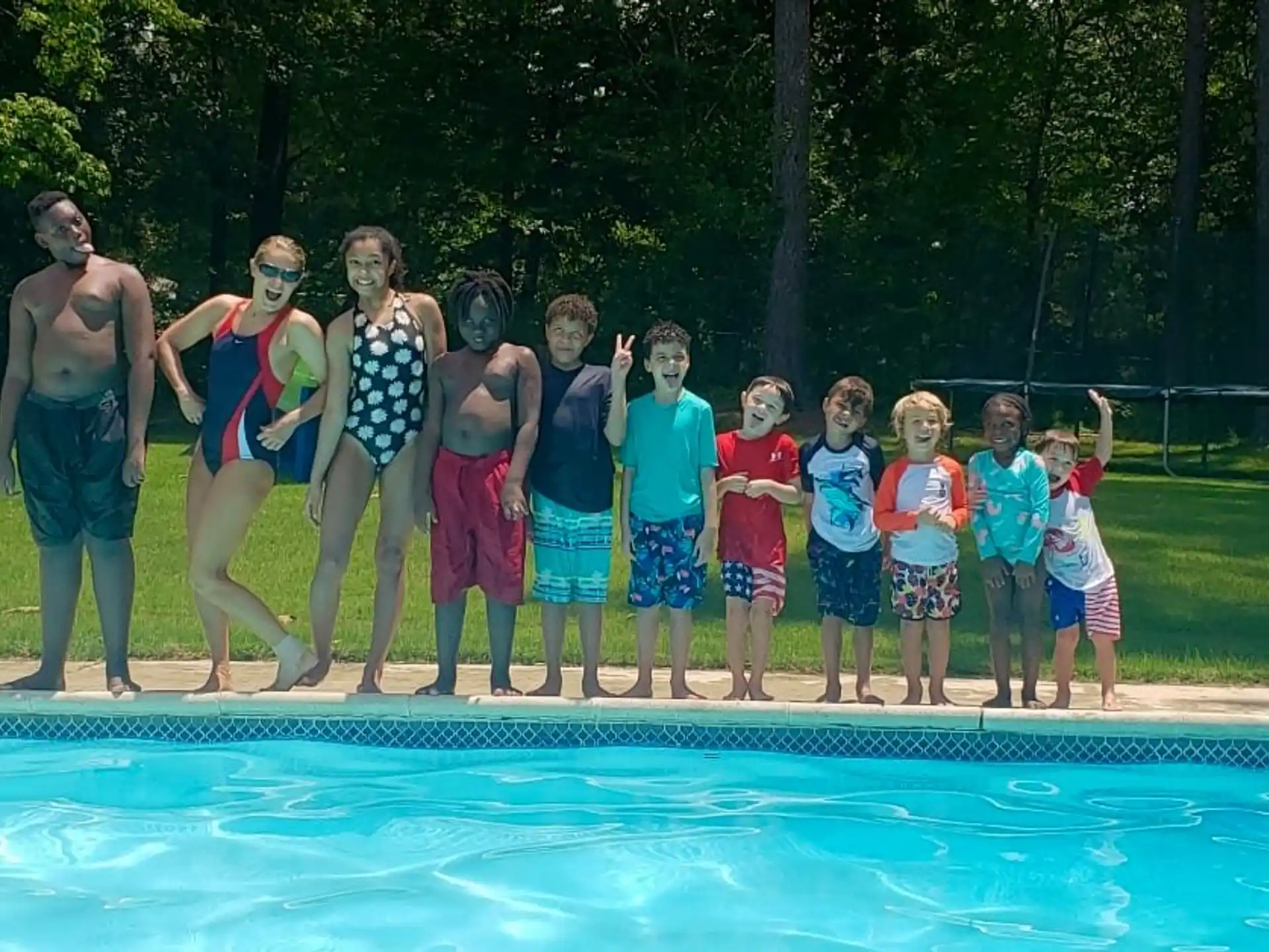 a group of people standing on a pool