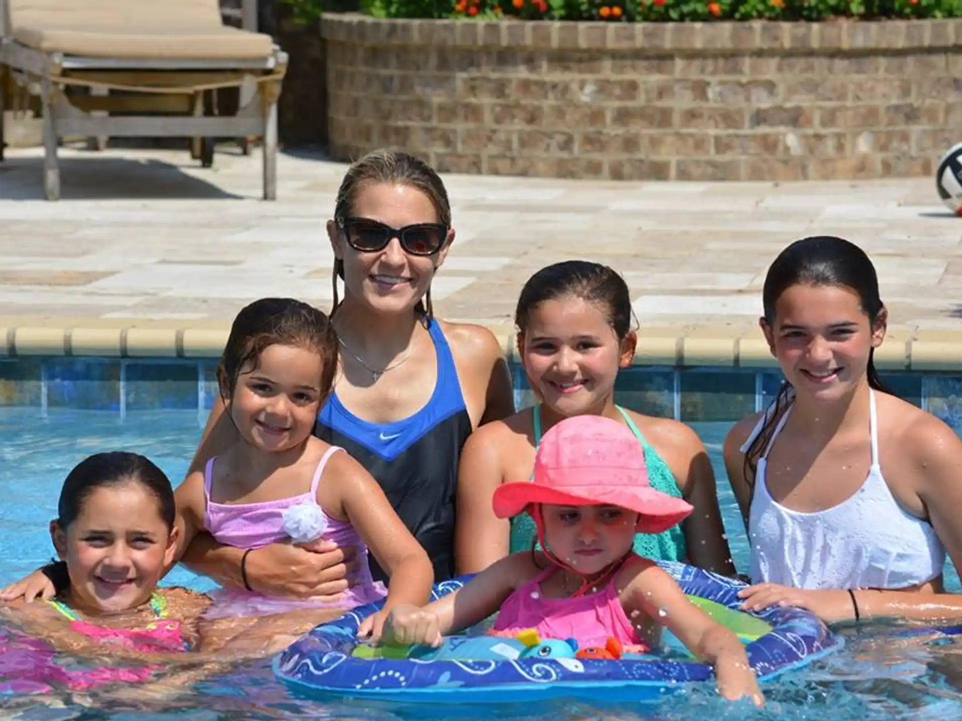 a group of women and children in a pool
