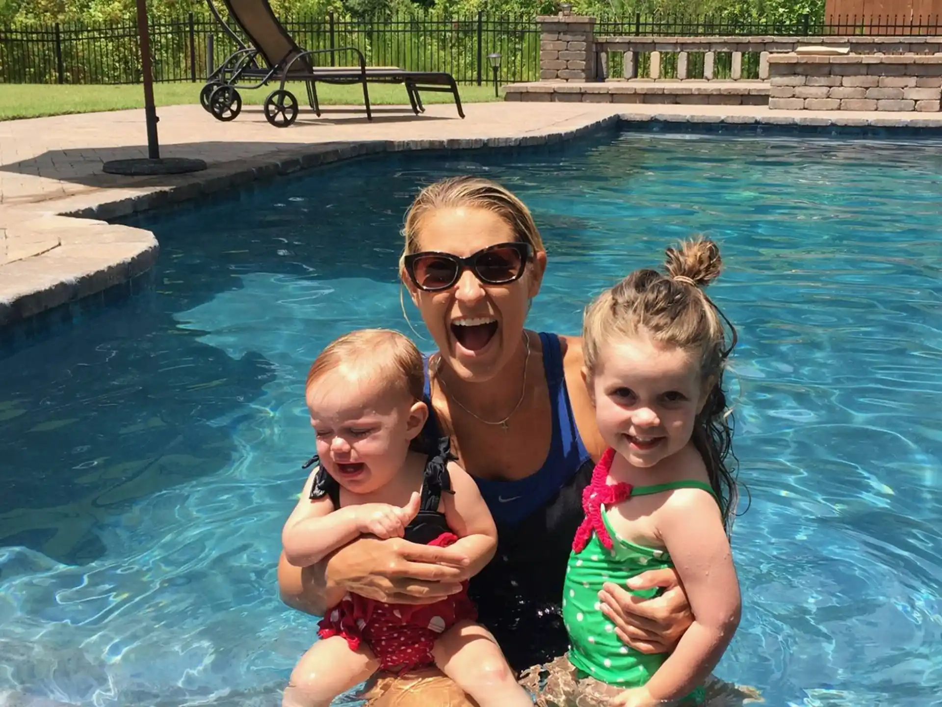 a person and two children in a pool