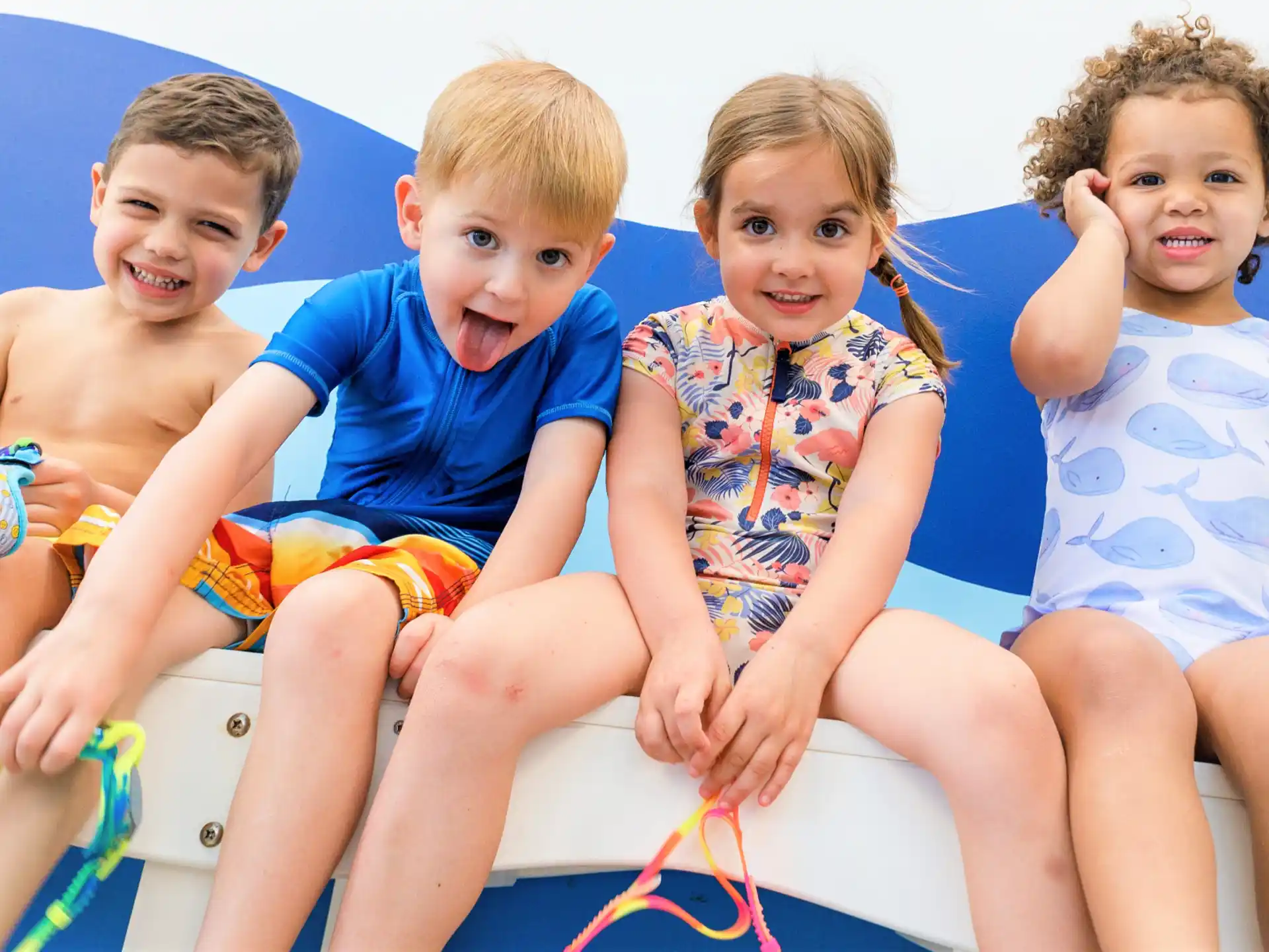 a group of children sitting in a pool