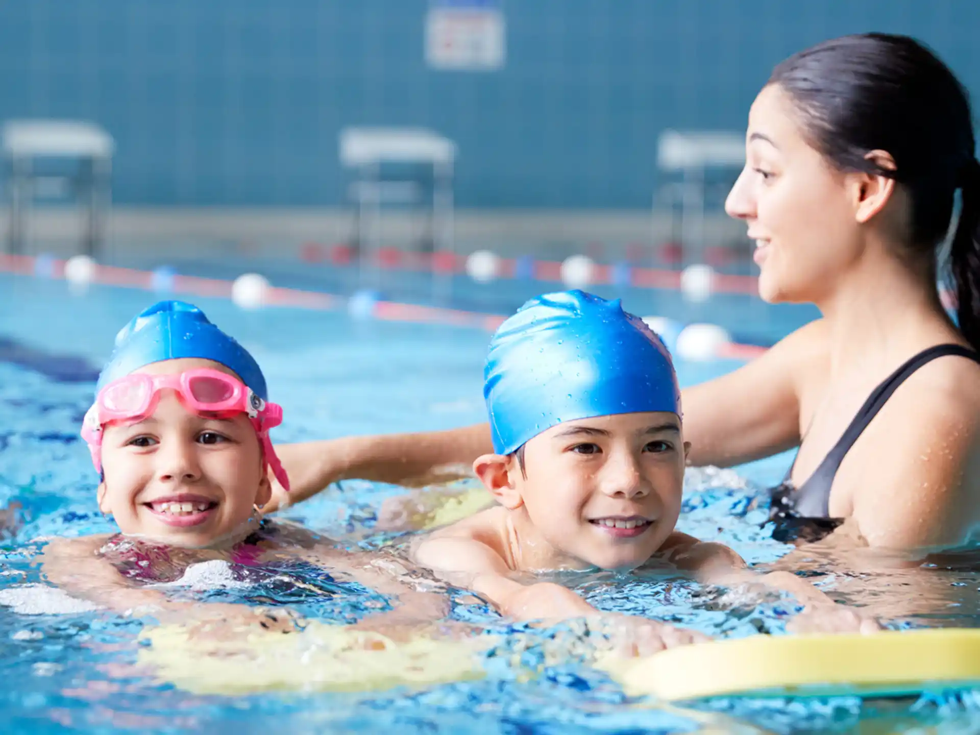 a person and two children in a pool