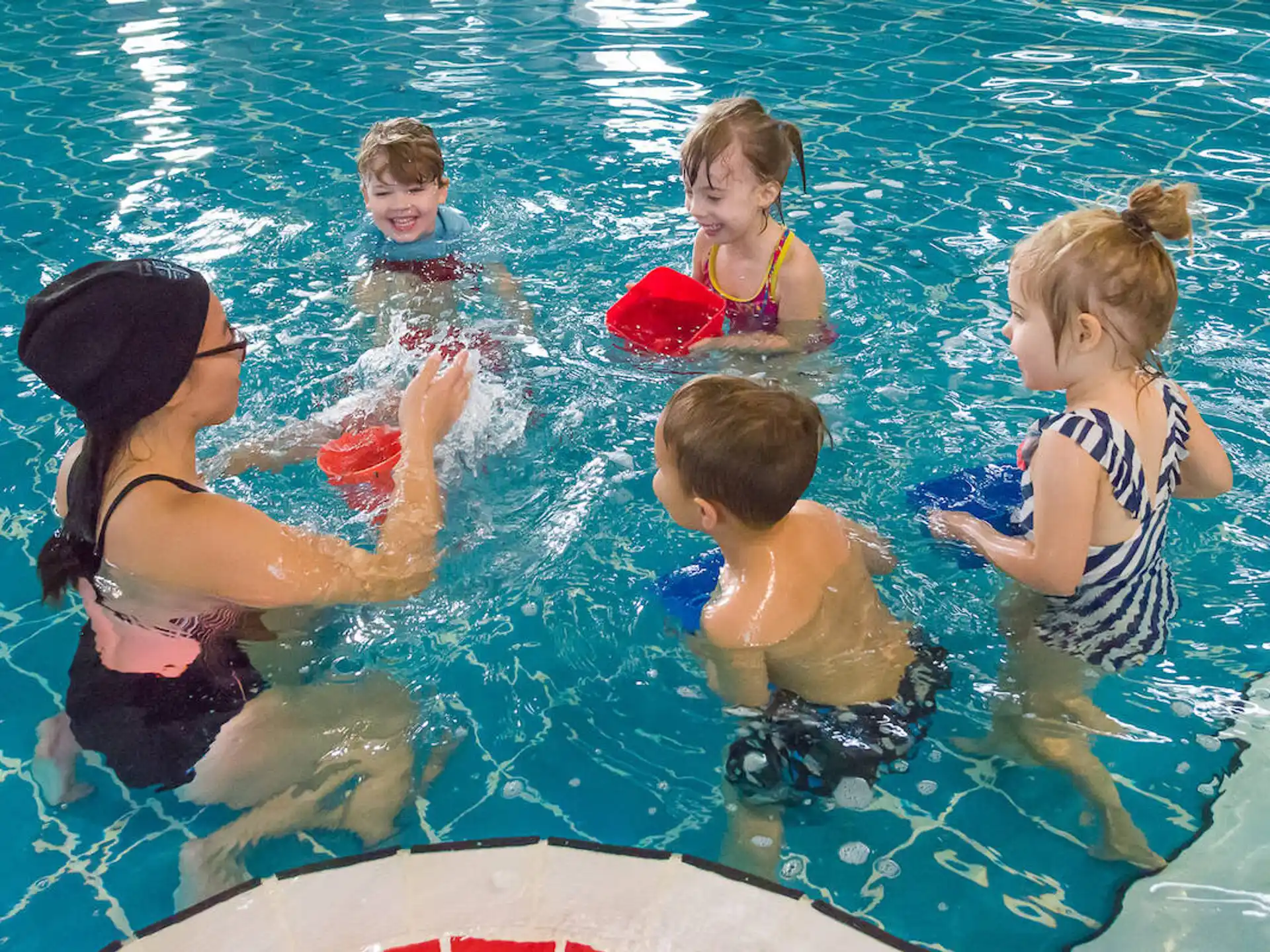 a group of children in a pool
