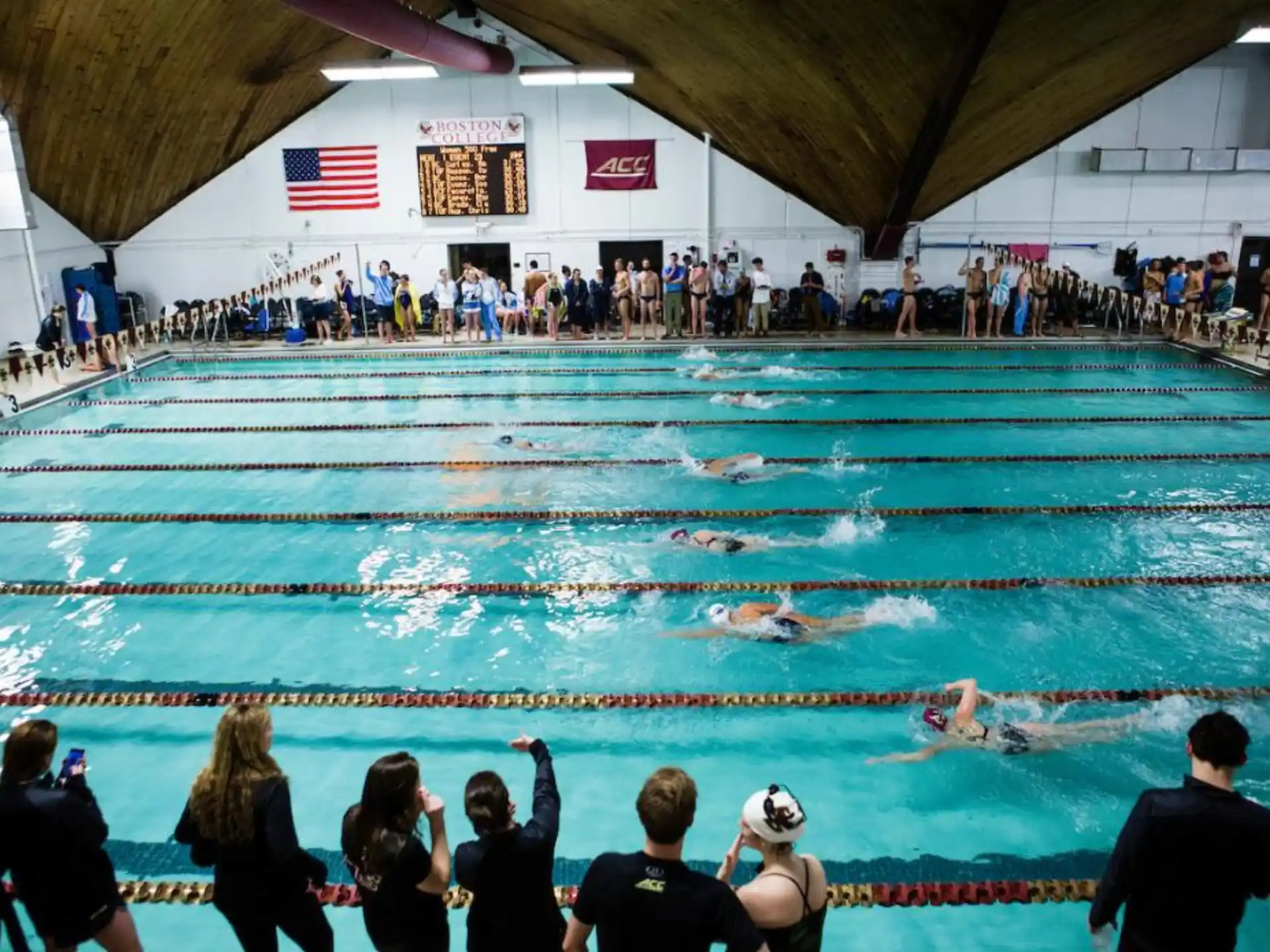 a person in a pool with a crowd watching