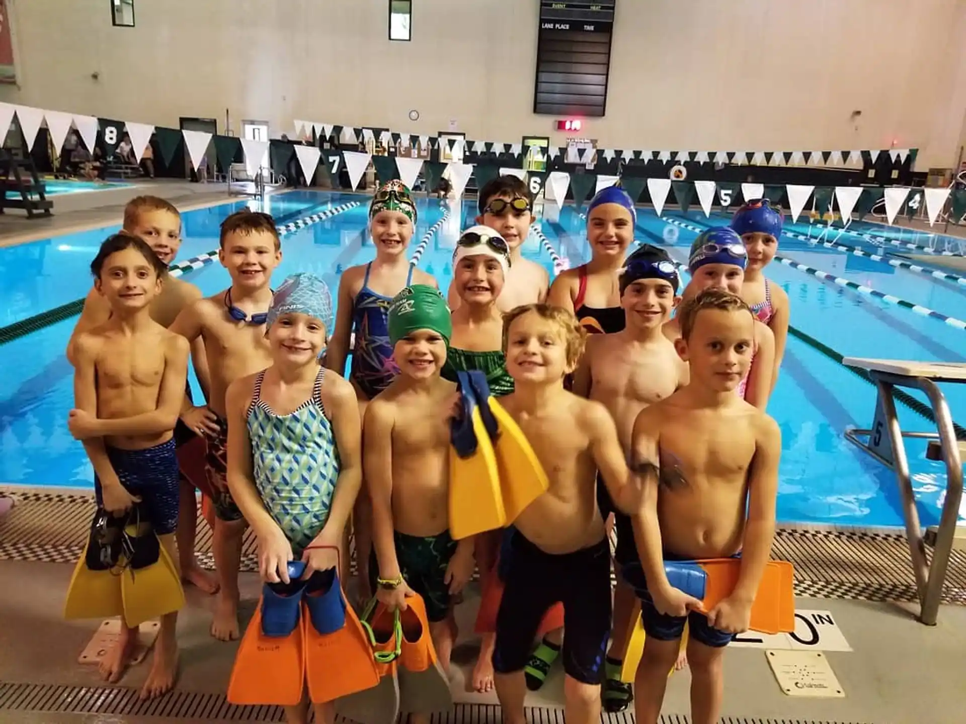 a group of people in swimsuits posing for a photo