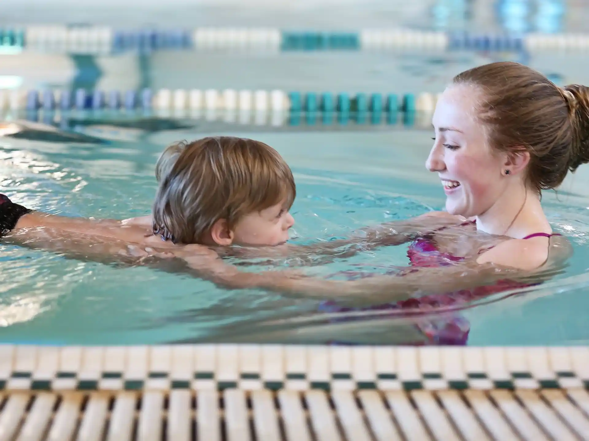 a person and a child in a pool