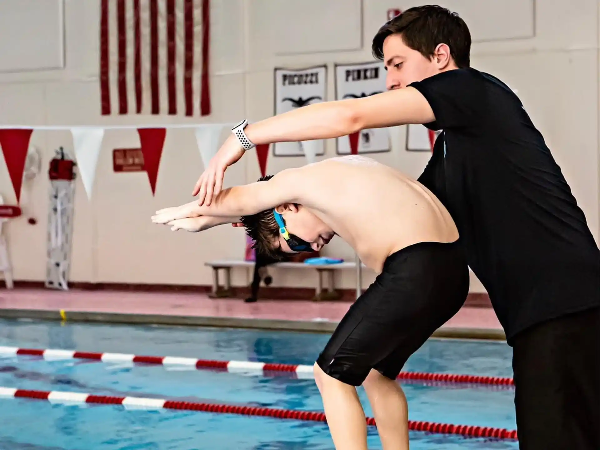 a person doing a handstand on a mat in a swimming pool