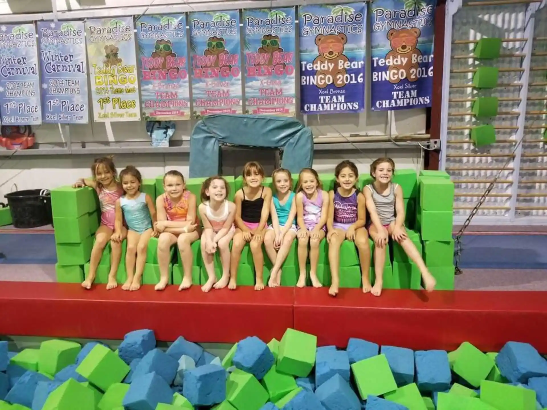 a group of children posing for a photo on a stage