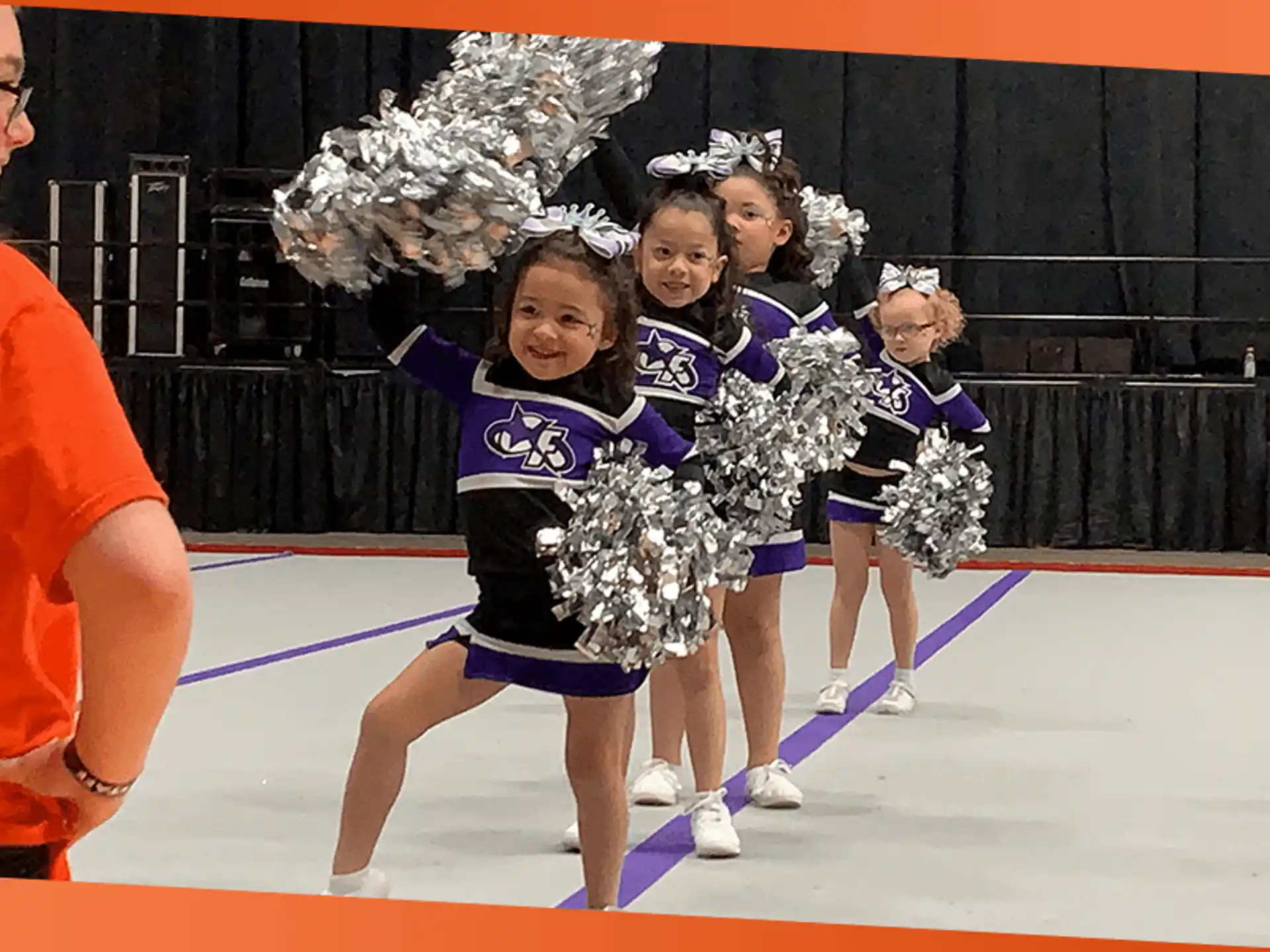 a group of cheerleaders on a basketball court
