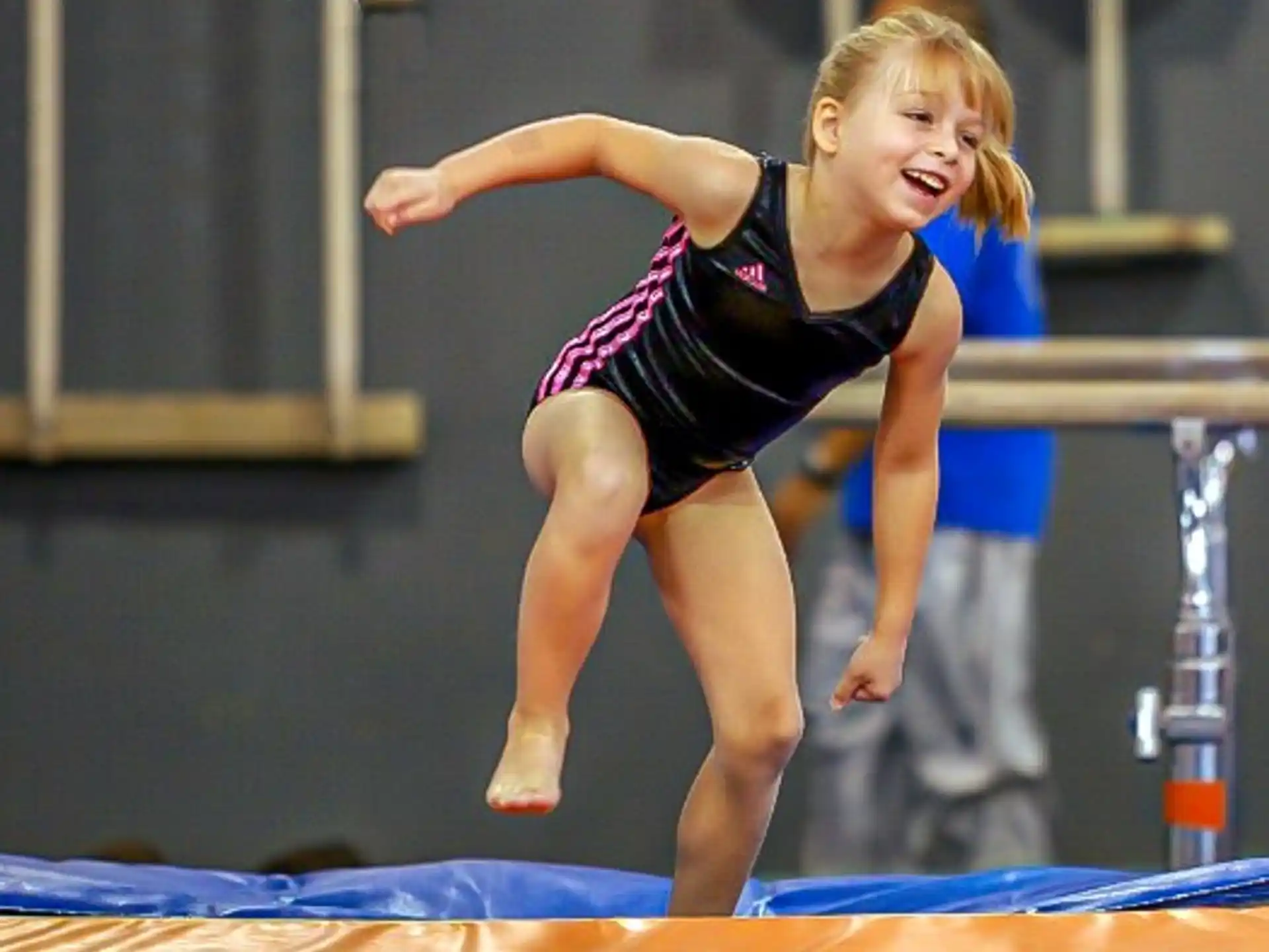 a girl jumping on a trampoline