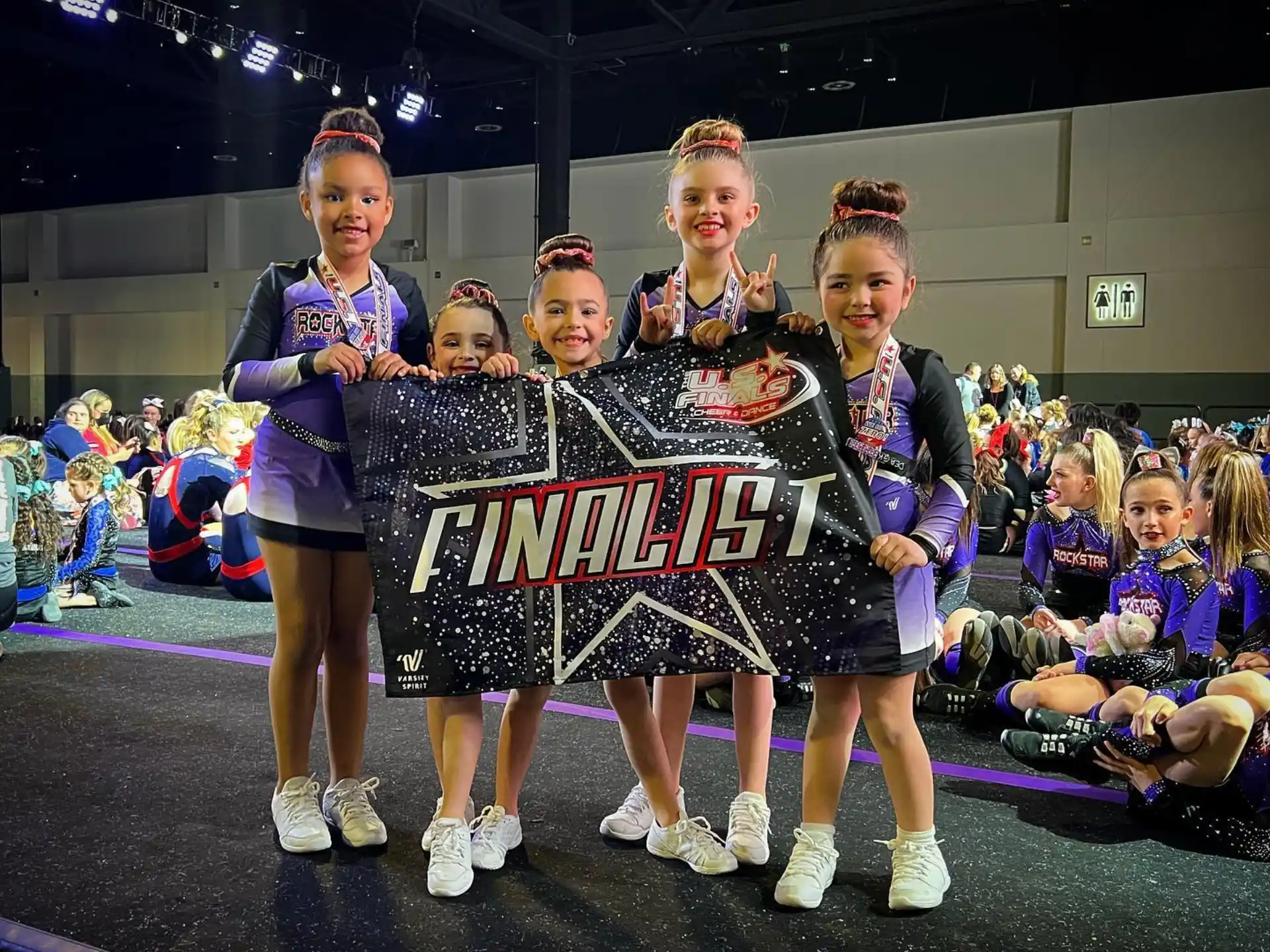 a group of girls holding a sign