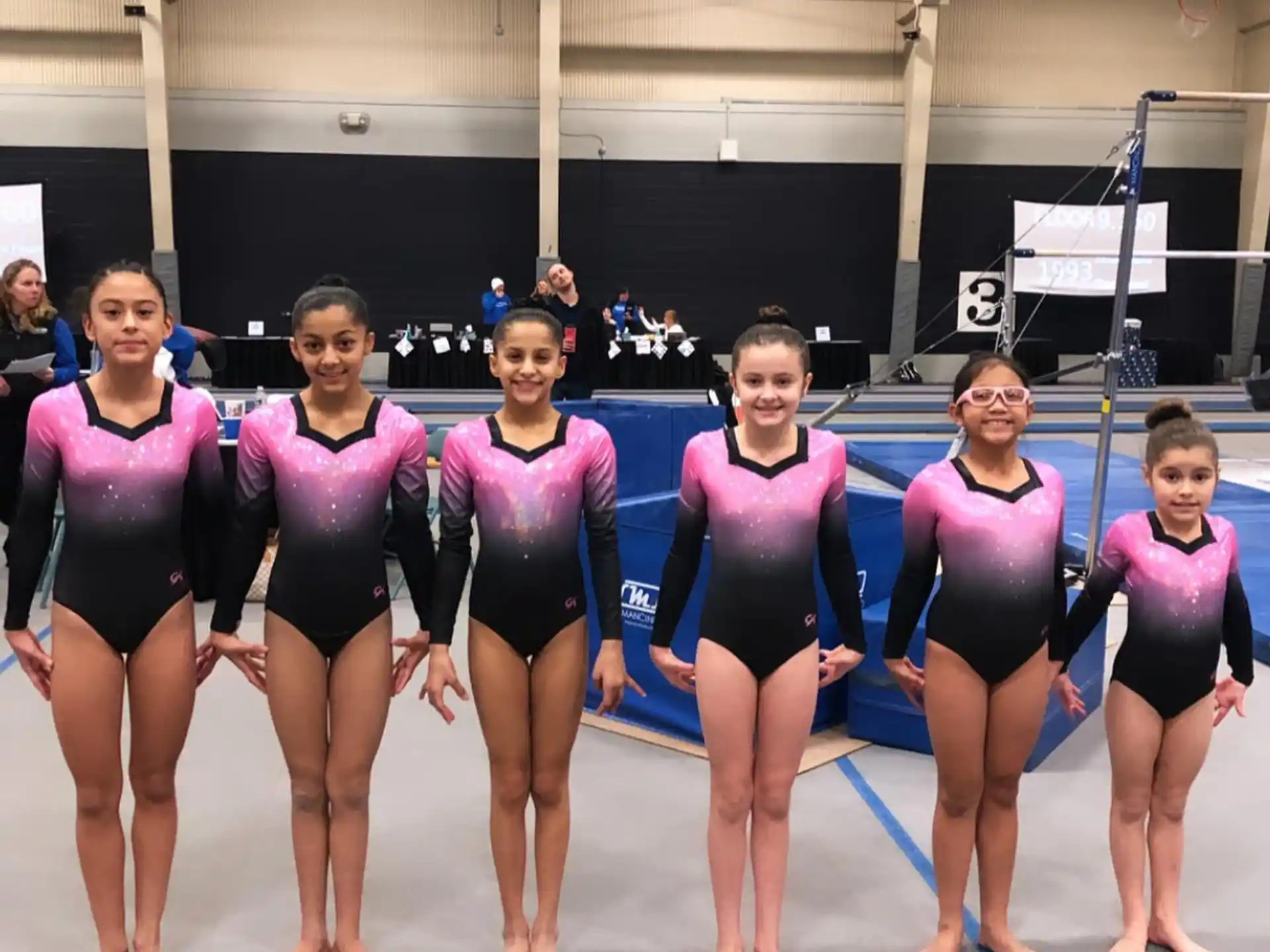 a group of women in leotards posing for a photo