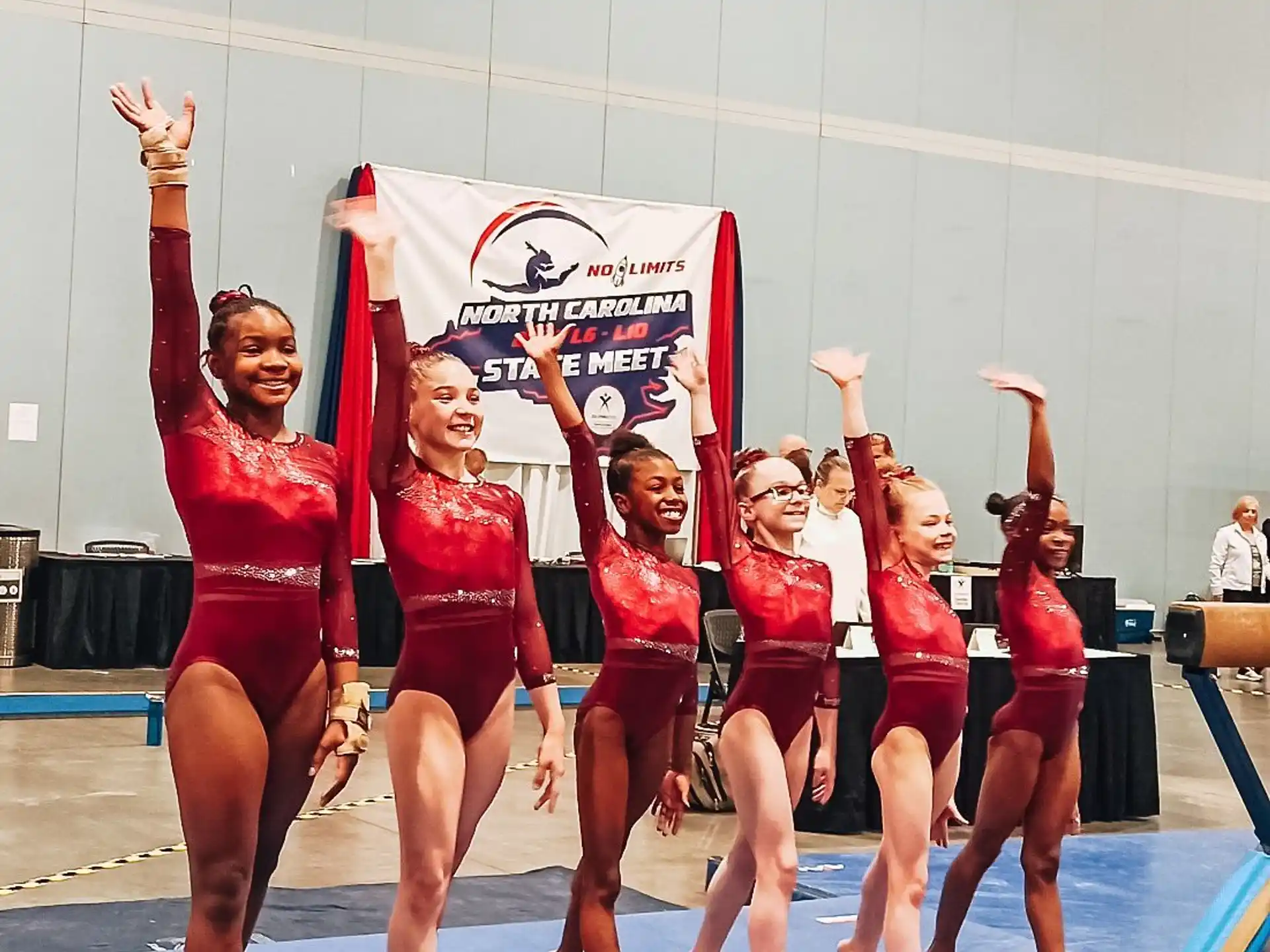 a group of women in leotards holding up a sign