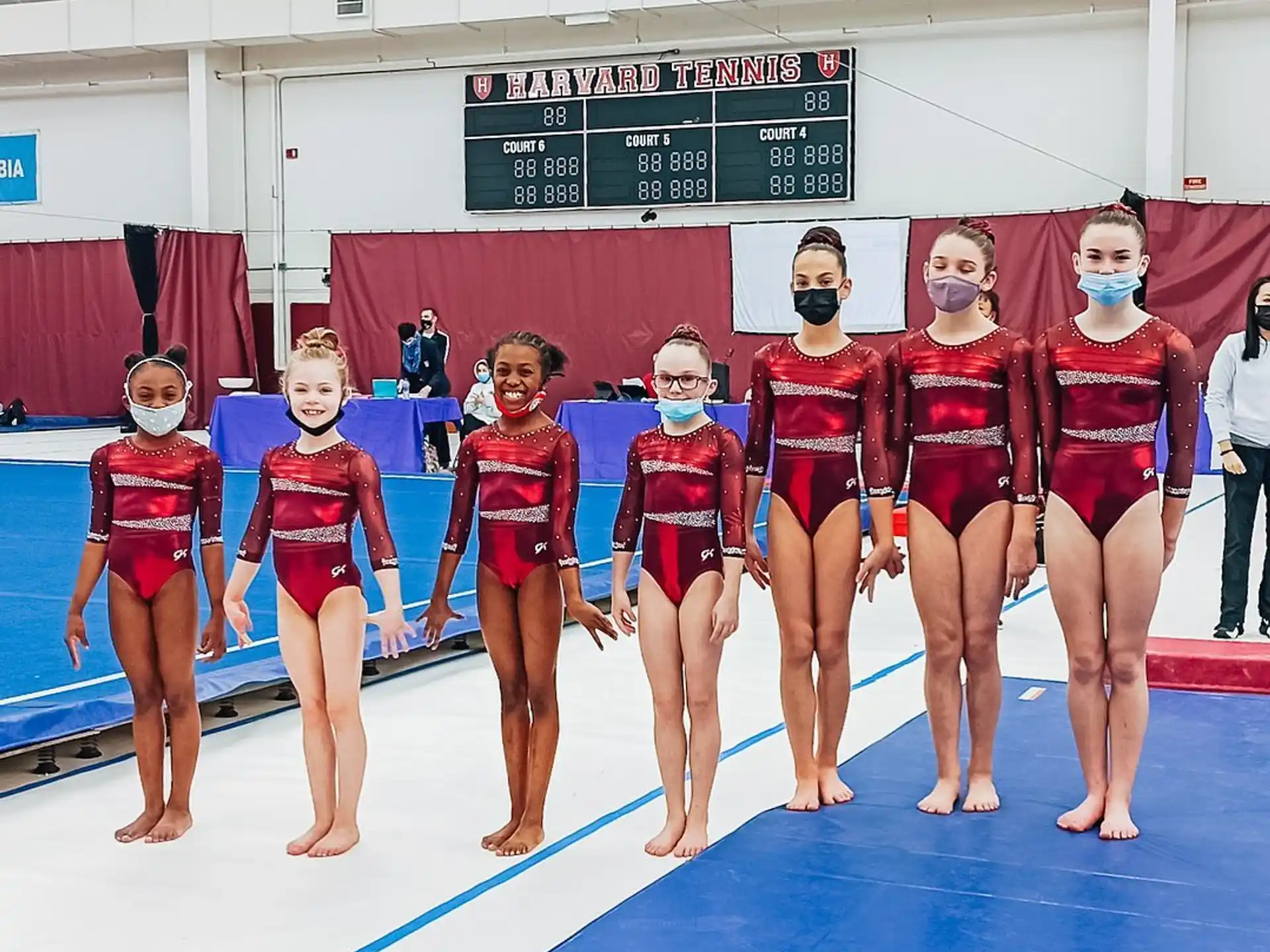 a group of women in leotards posing for a photo