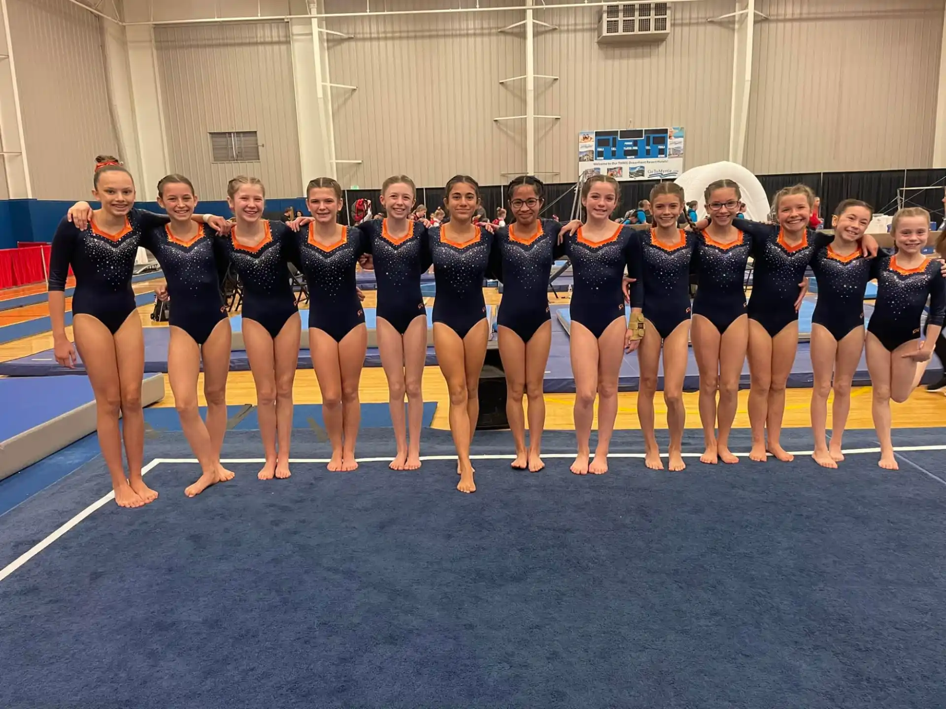 a group of women in swimsuits posing for a photo