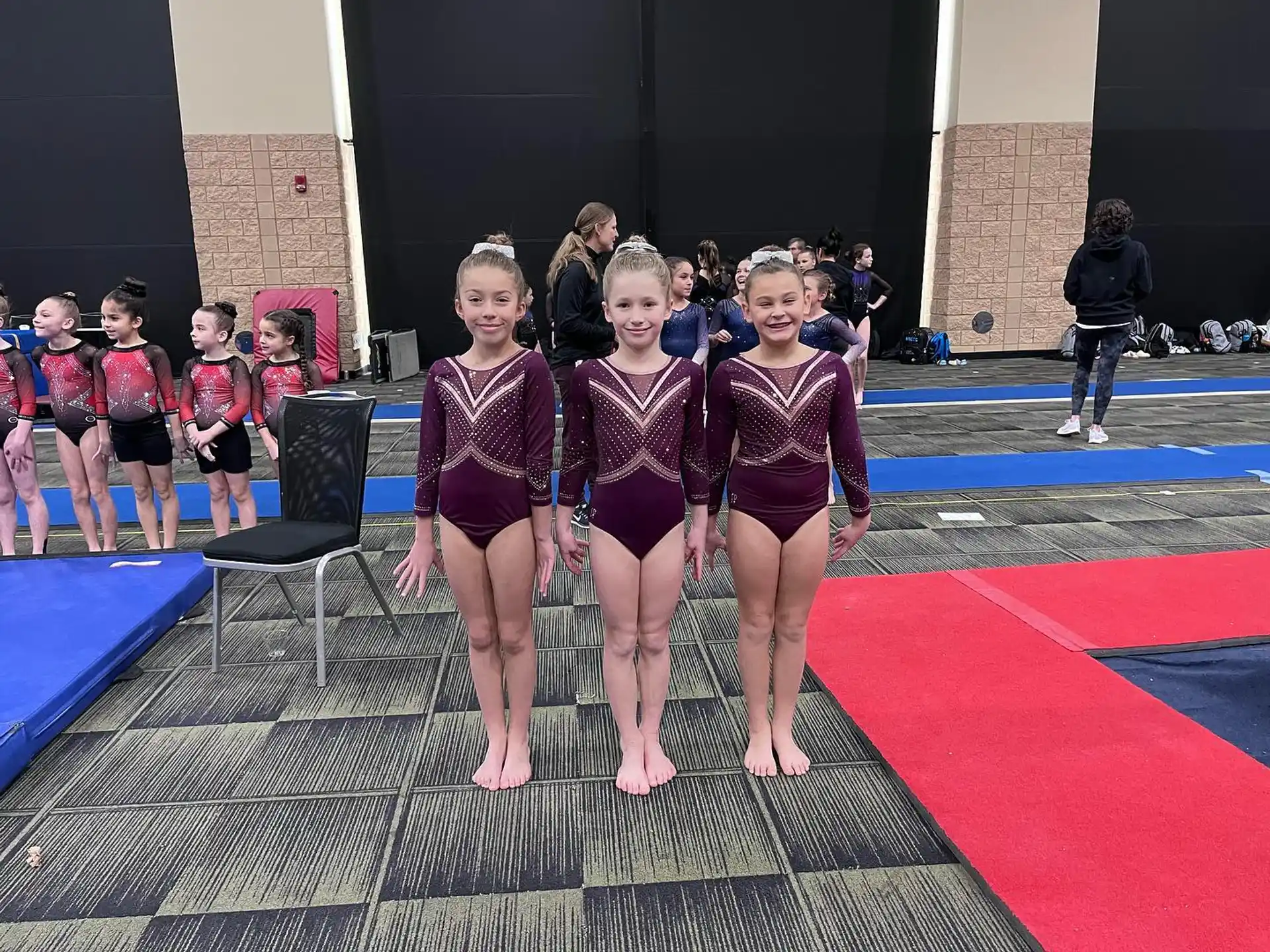 a group of girls in leotards posing for a photo