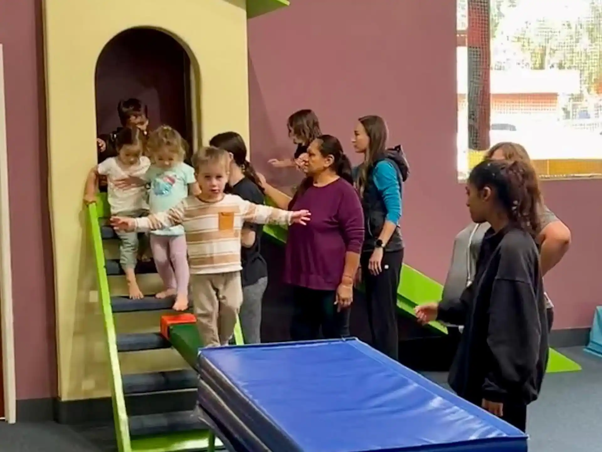 a group of children standing in a room
