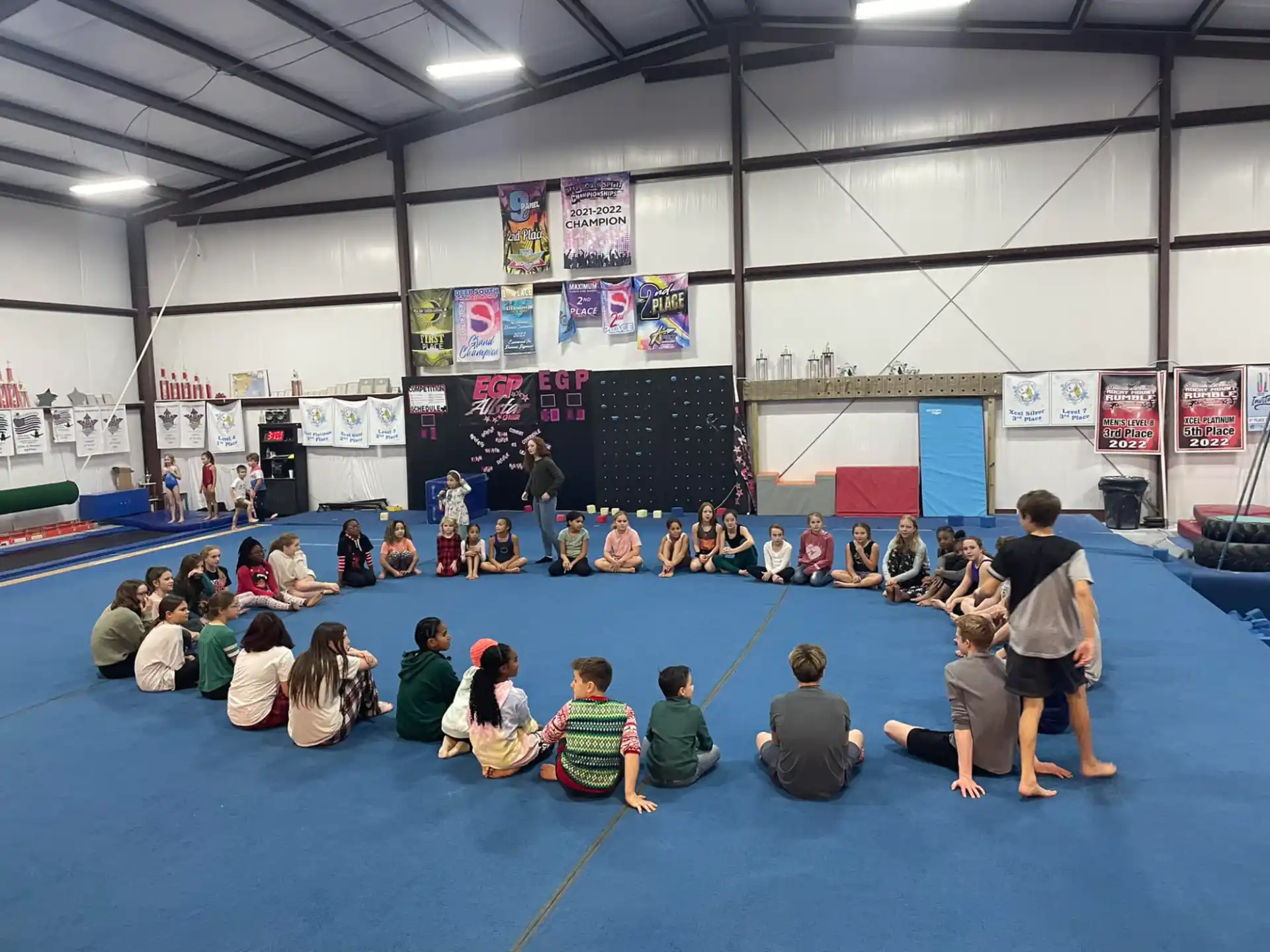 a group of people sitting on the floor in a room