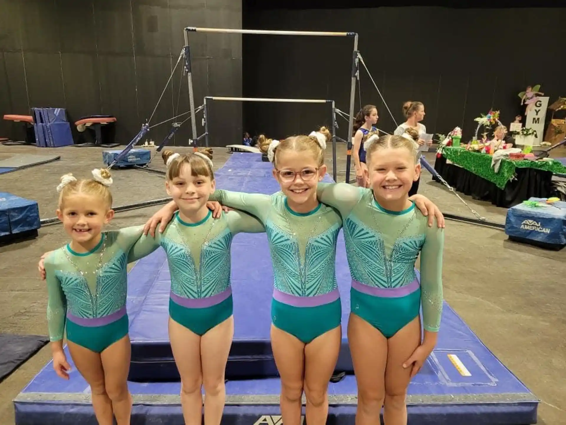 a group of girls in swimsuits posing for a photo