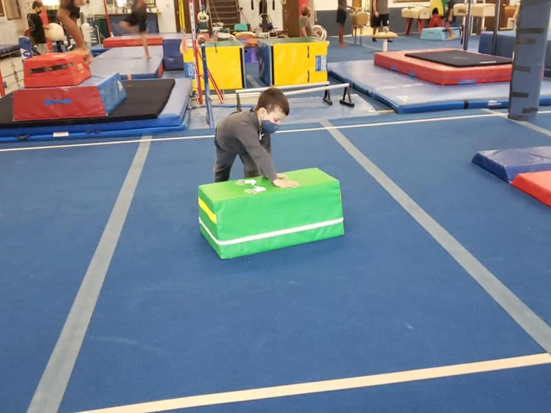 a boy sitting on a mat