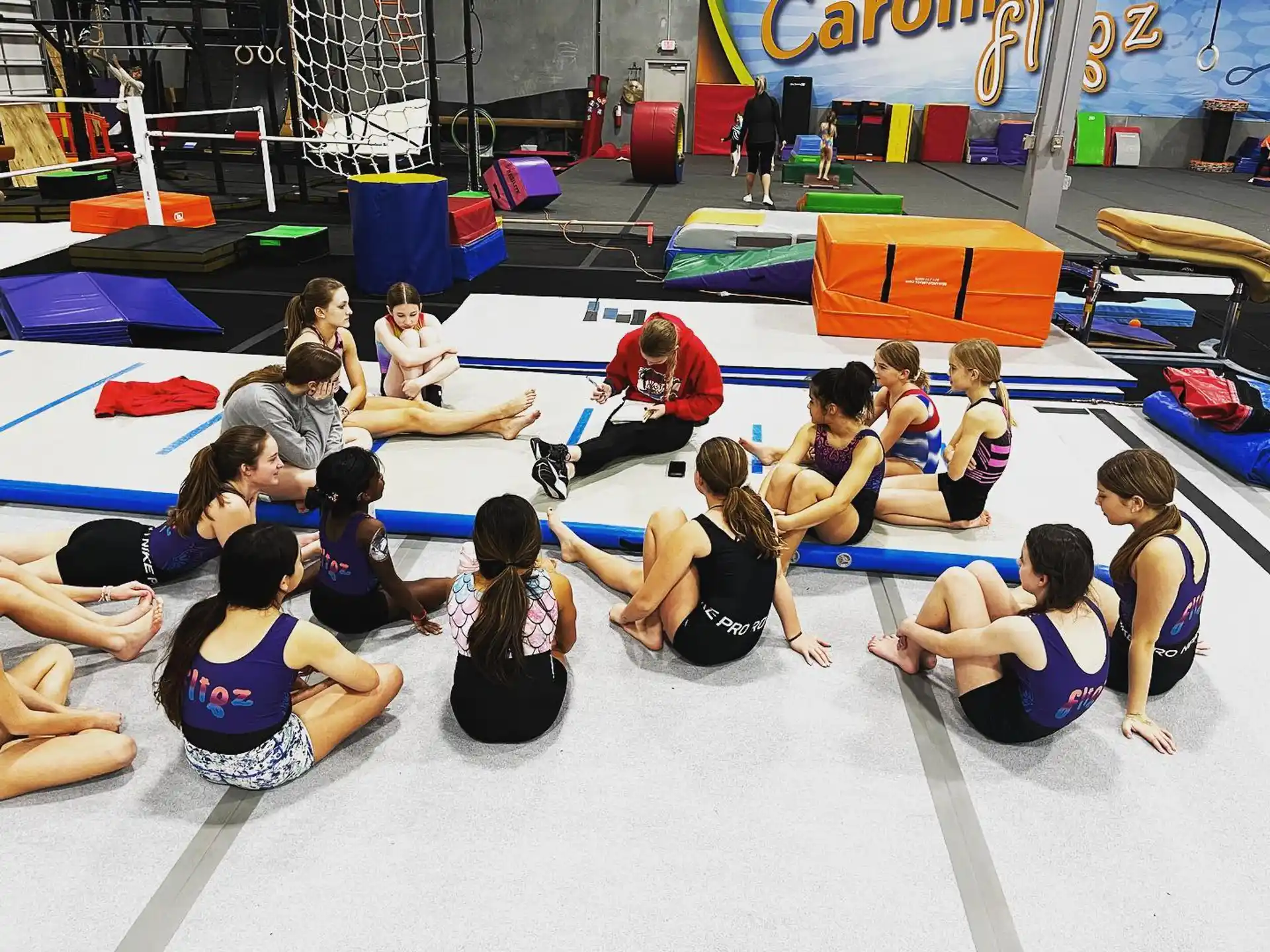 a group of people sitting on mats