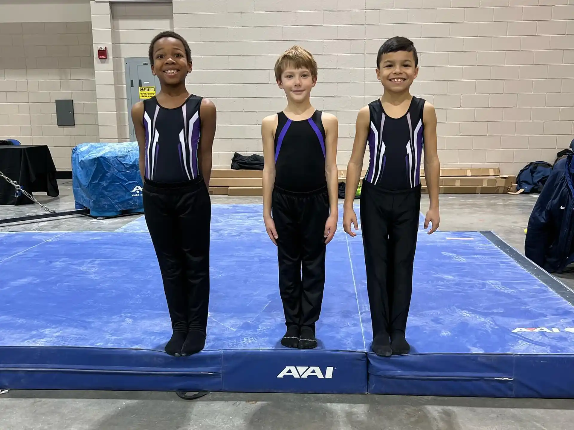 a group of women in leotards standing on a mat