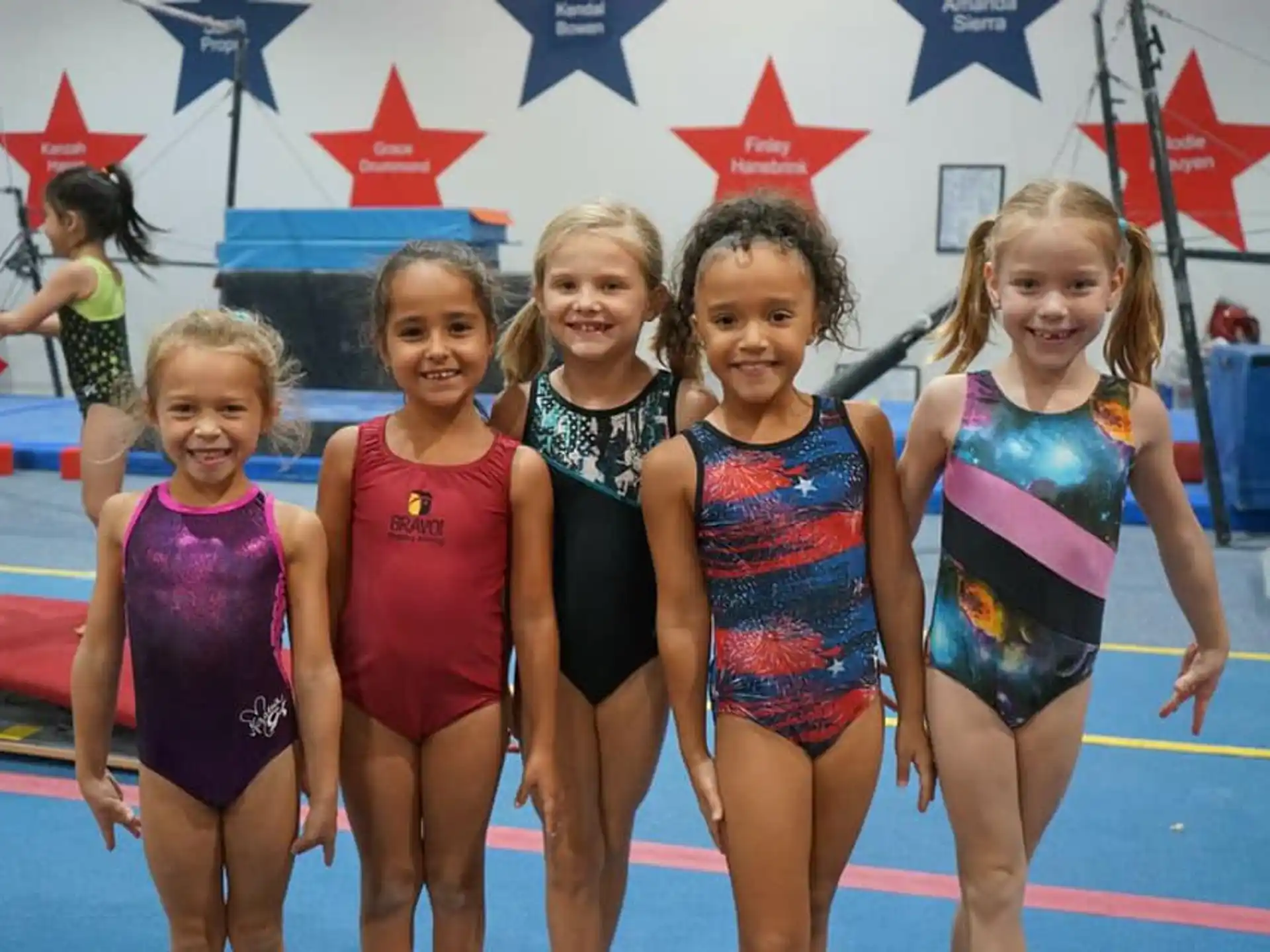 a group of girls in swimsuits posing for a photo