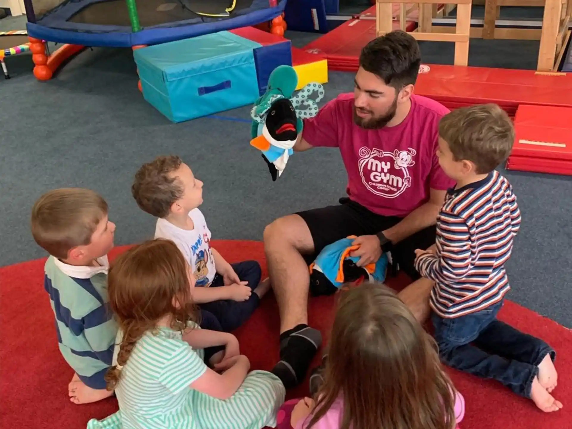 a person and several children playing with a toy