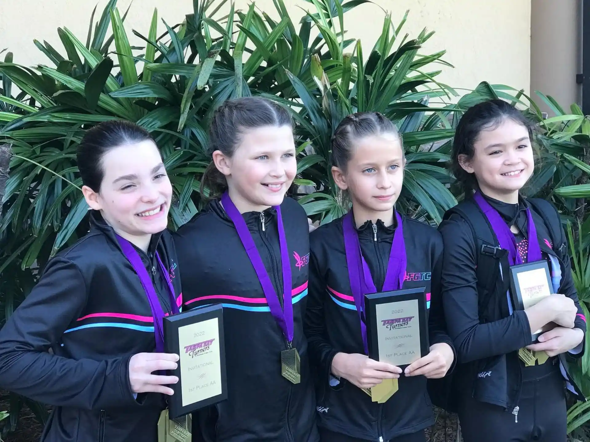 a group of young girls holding certificates