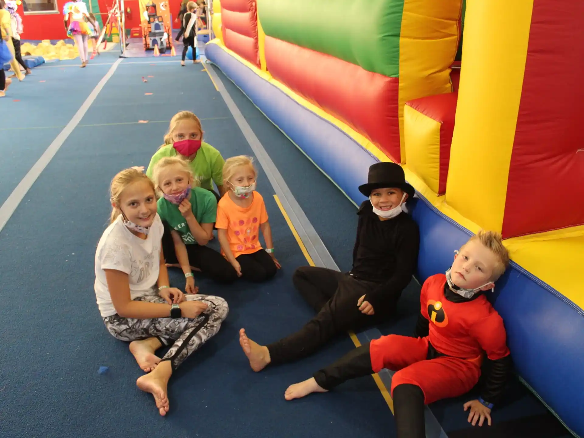 a group of people sitting on a colorful floor