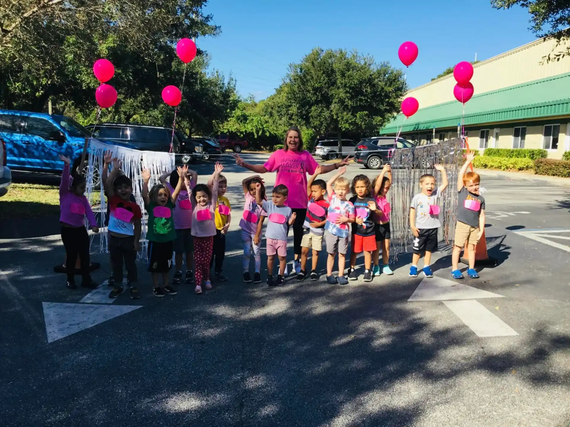 a group of children holding balloons
