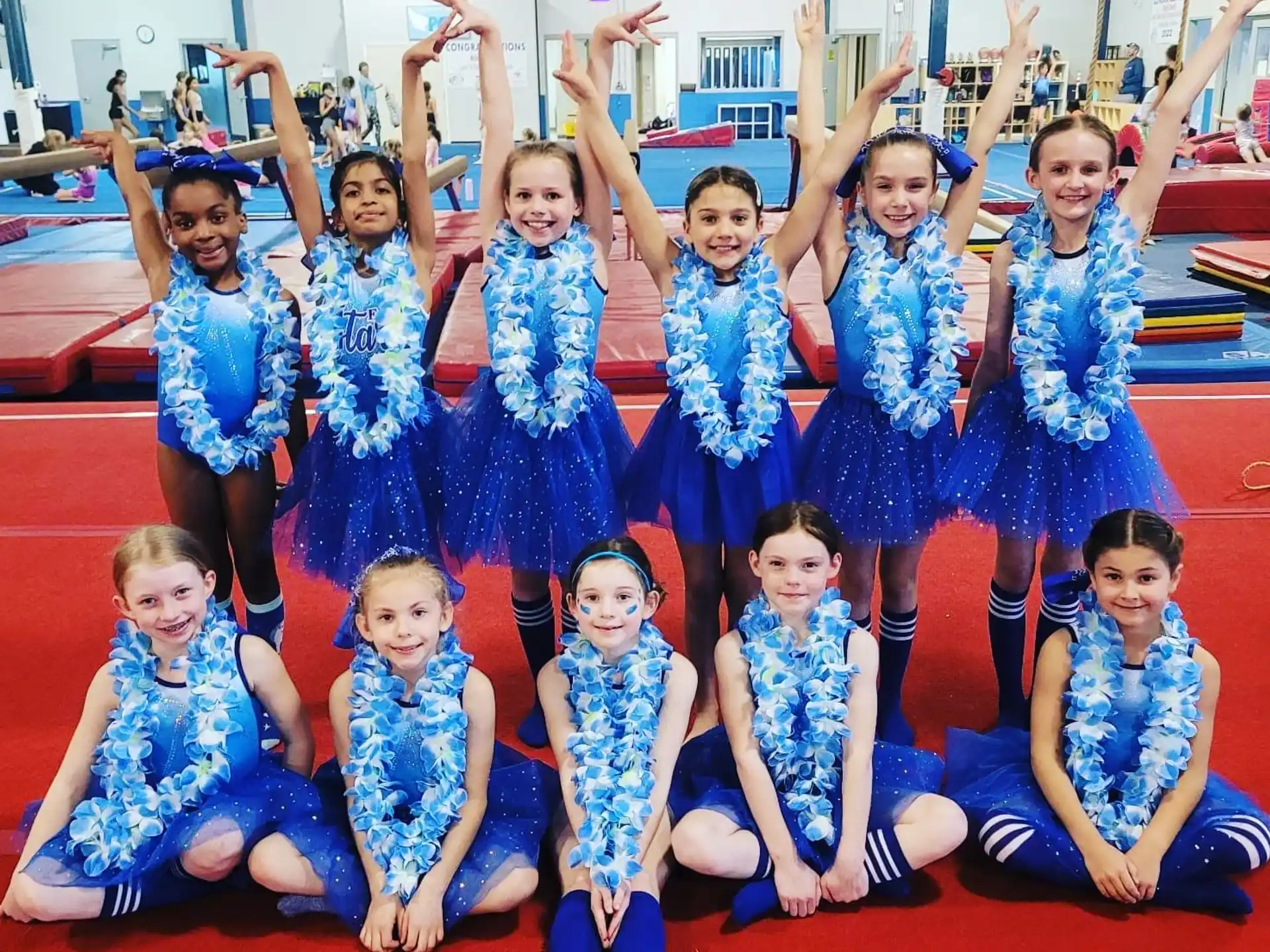 a group of girls in blue dresses