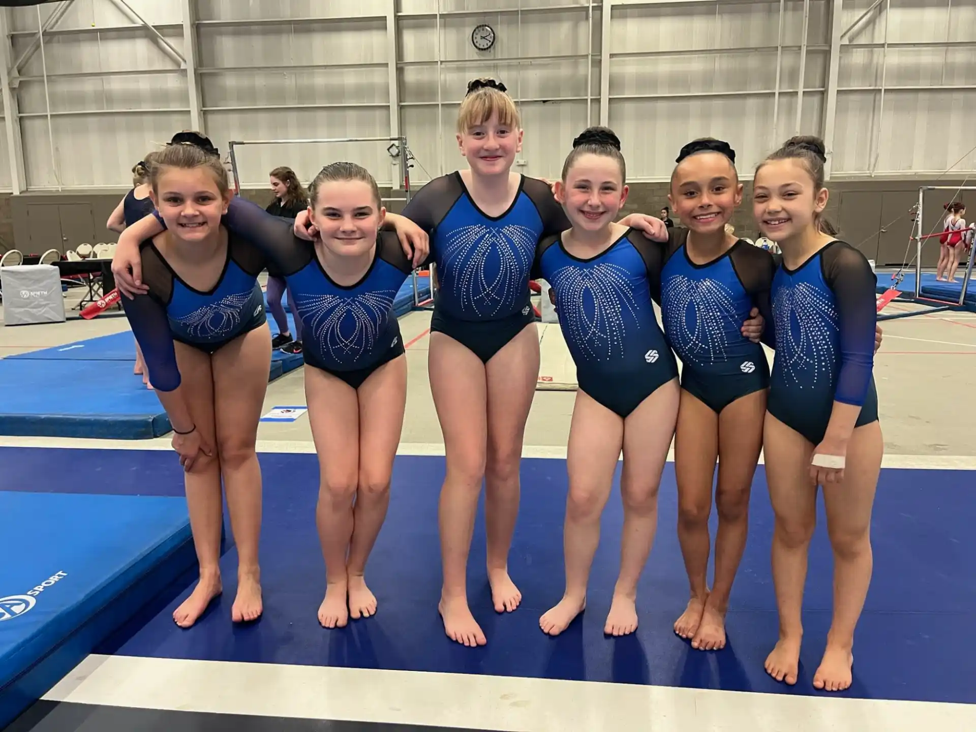 a group of girls in swimsuits posing for a photo