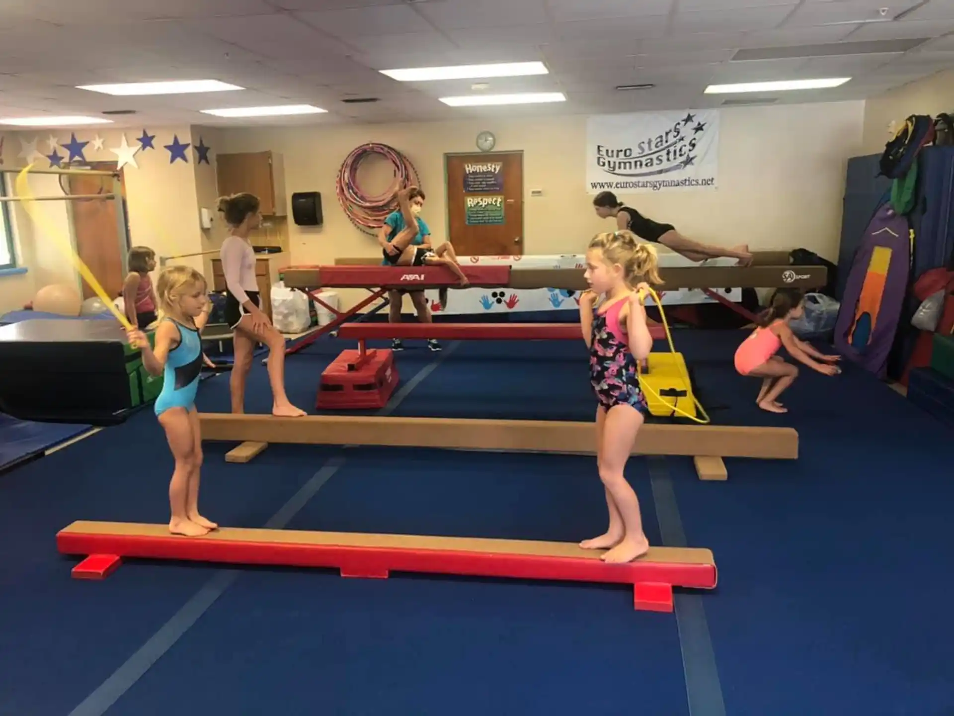 a group of children exercising in a gym